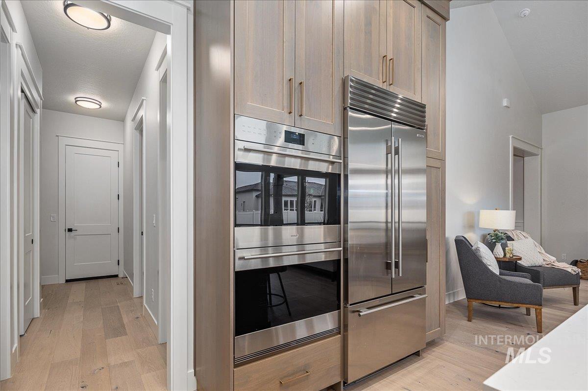 Kitchen with appliances with stainless steel finishes and light wood-type flooring