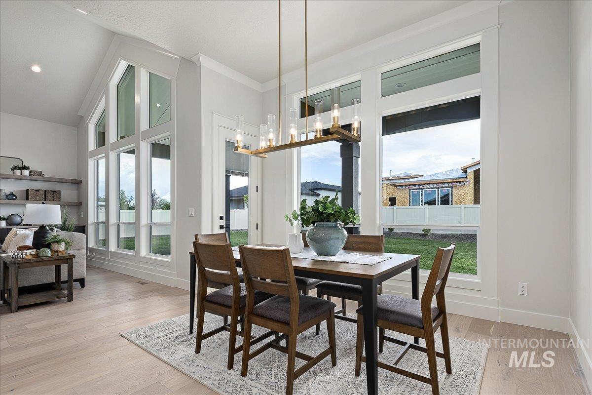 Dining room with light wood-style flooring and plenty of natural light