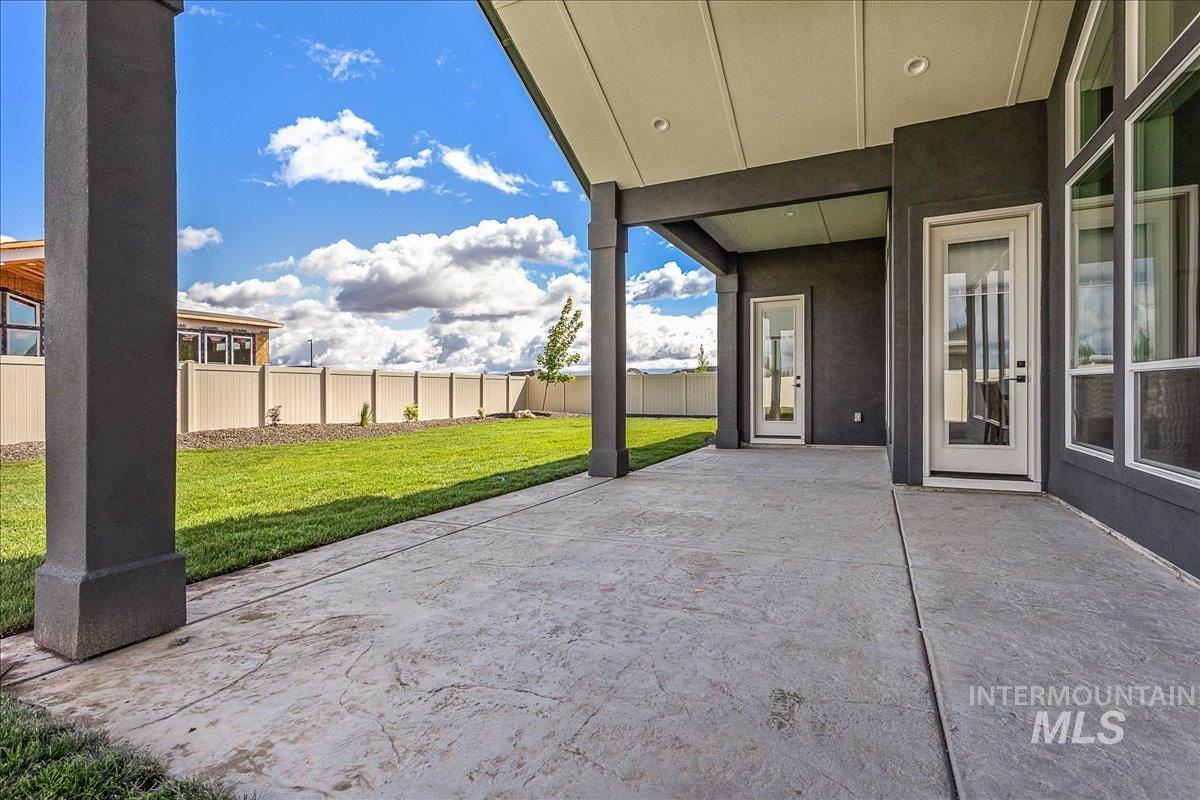 Fenced backyard with a patio area