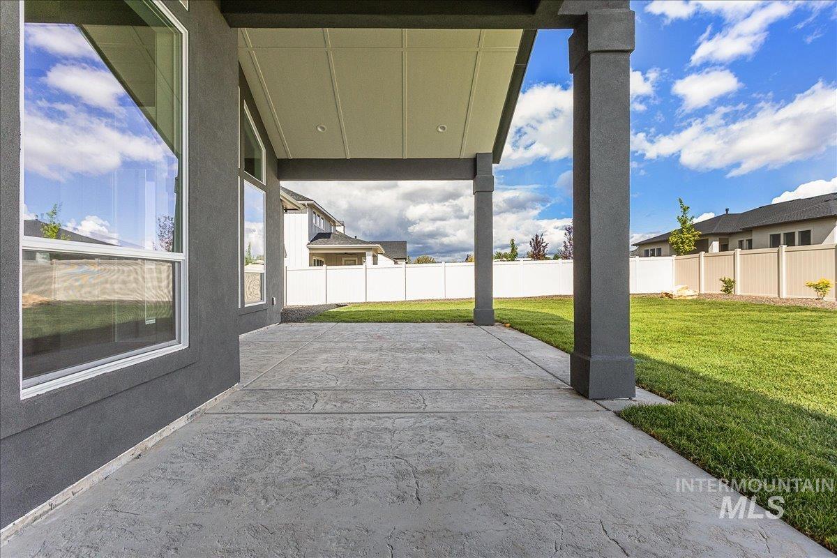 Fenced backyard featuring a patio