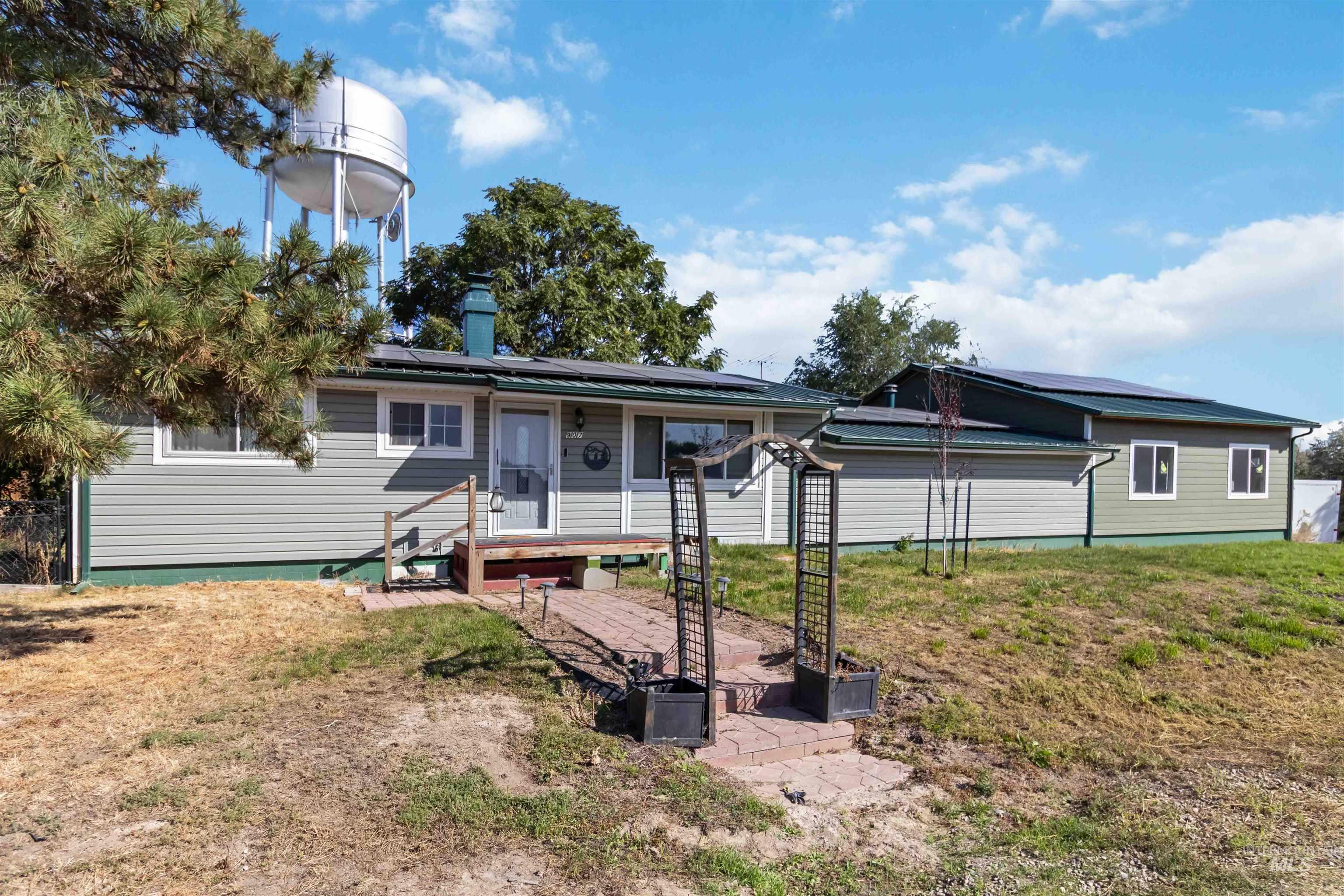 Ranch-style home featuring roof mounted solar panels