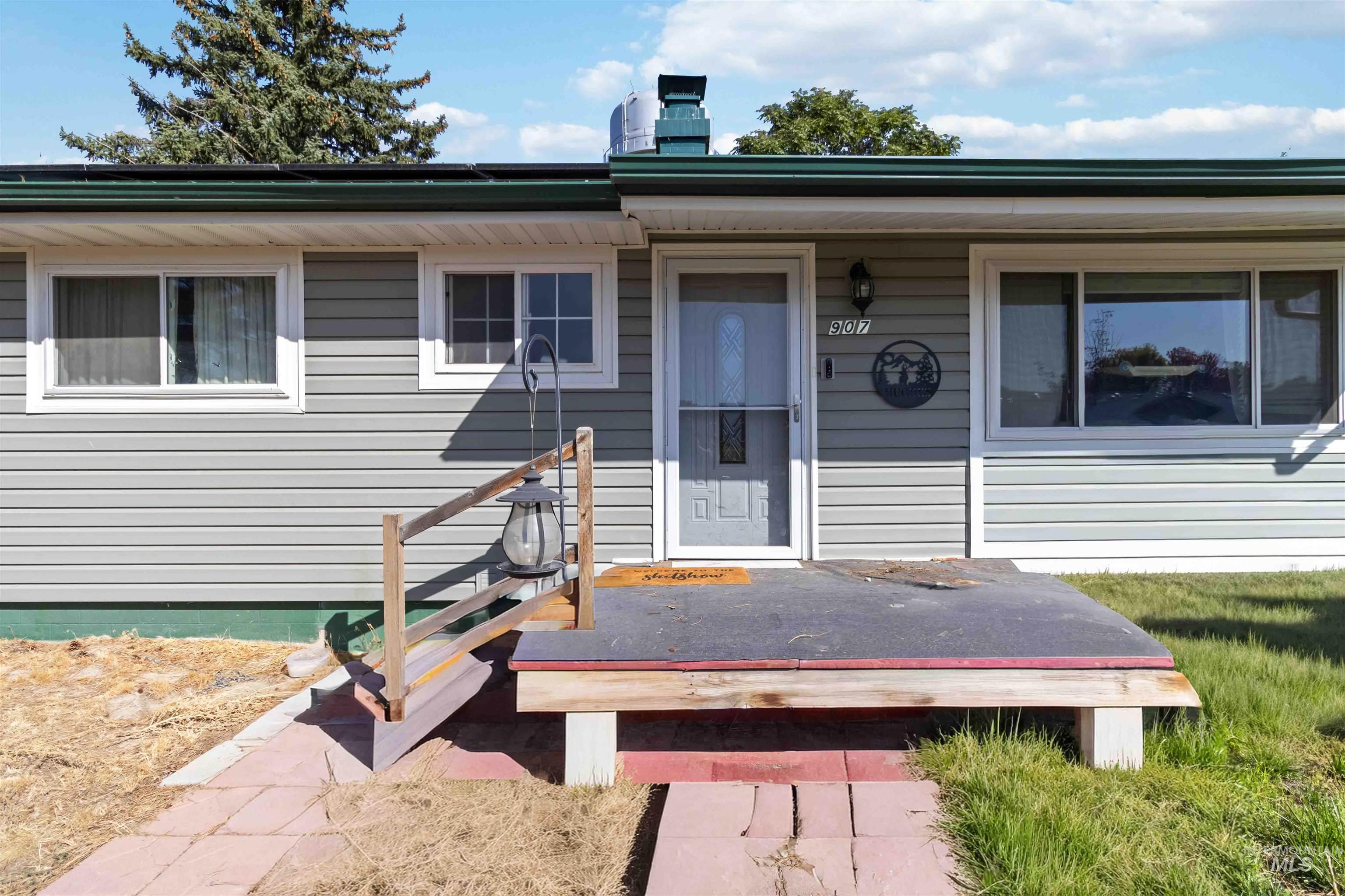 View of exterior entry featuring a chimney