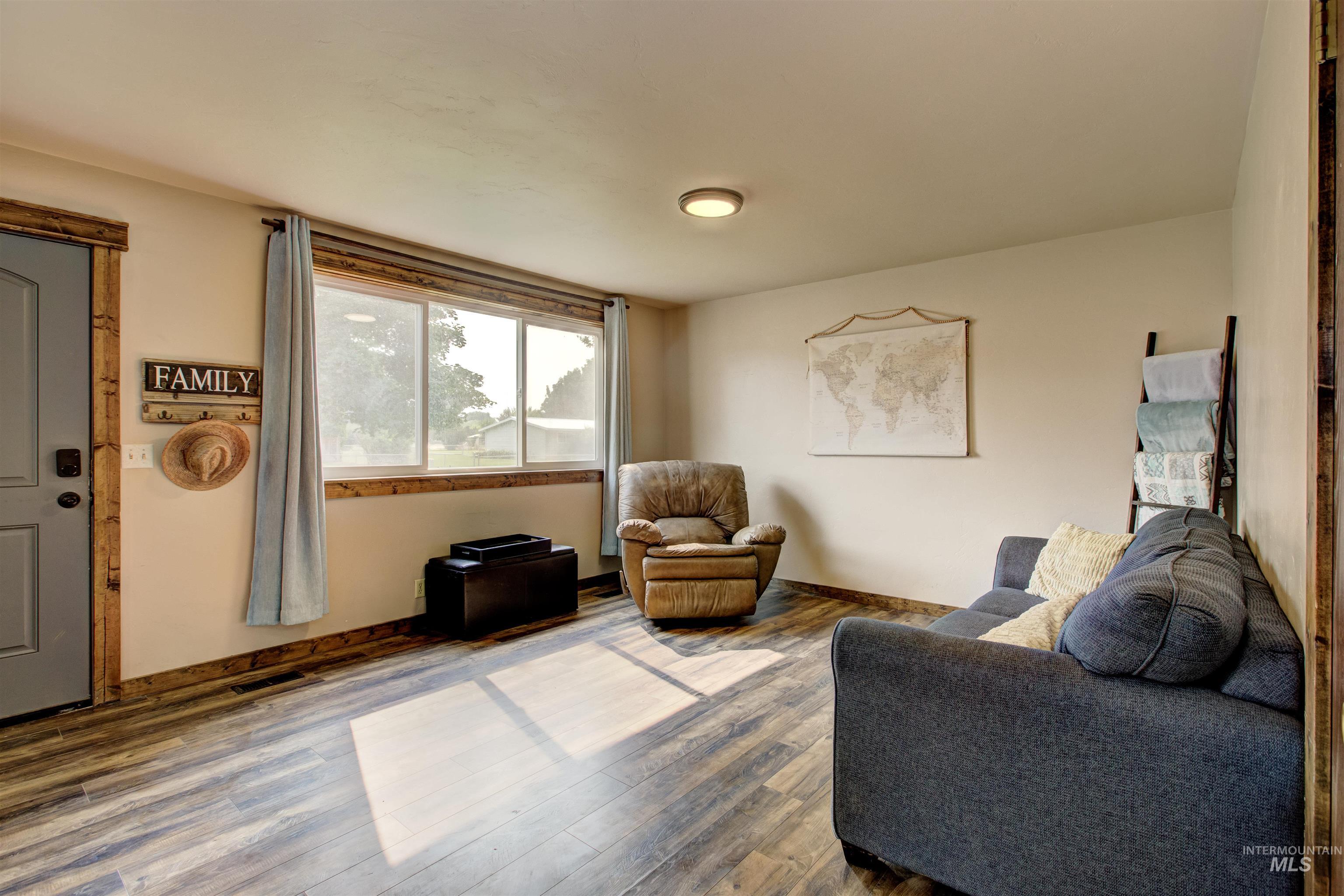 Sitting room with wood finished floors and baseboards
