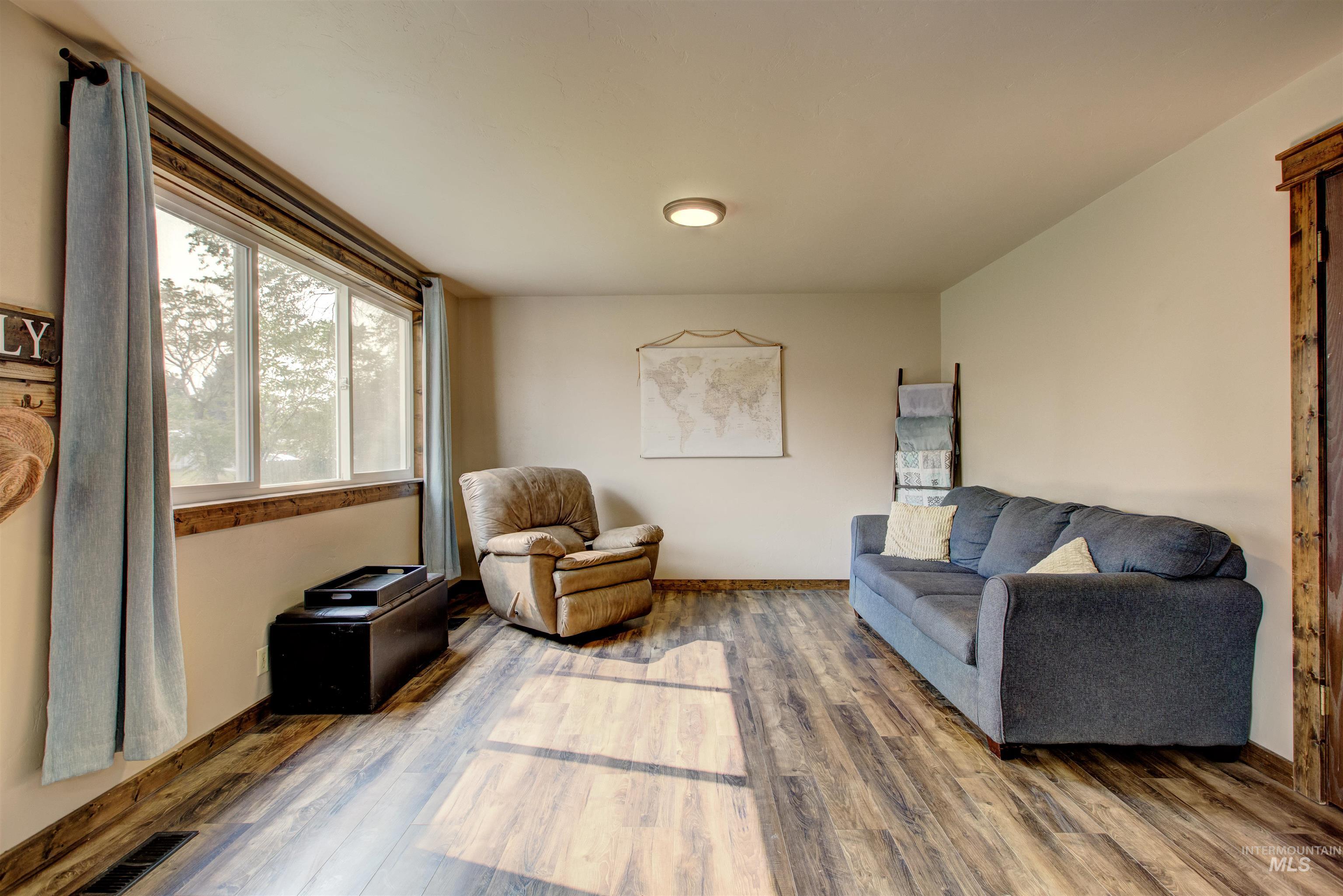 Living room with wood finished floors and baseboards
