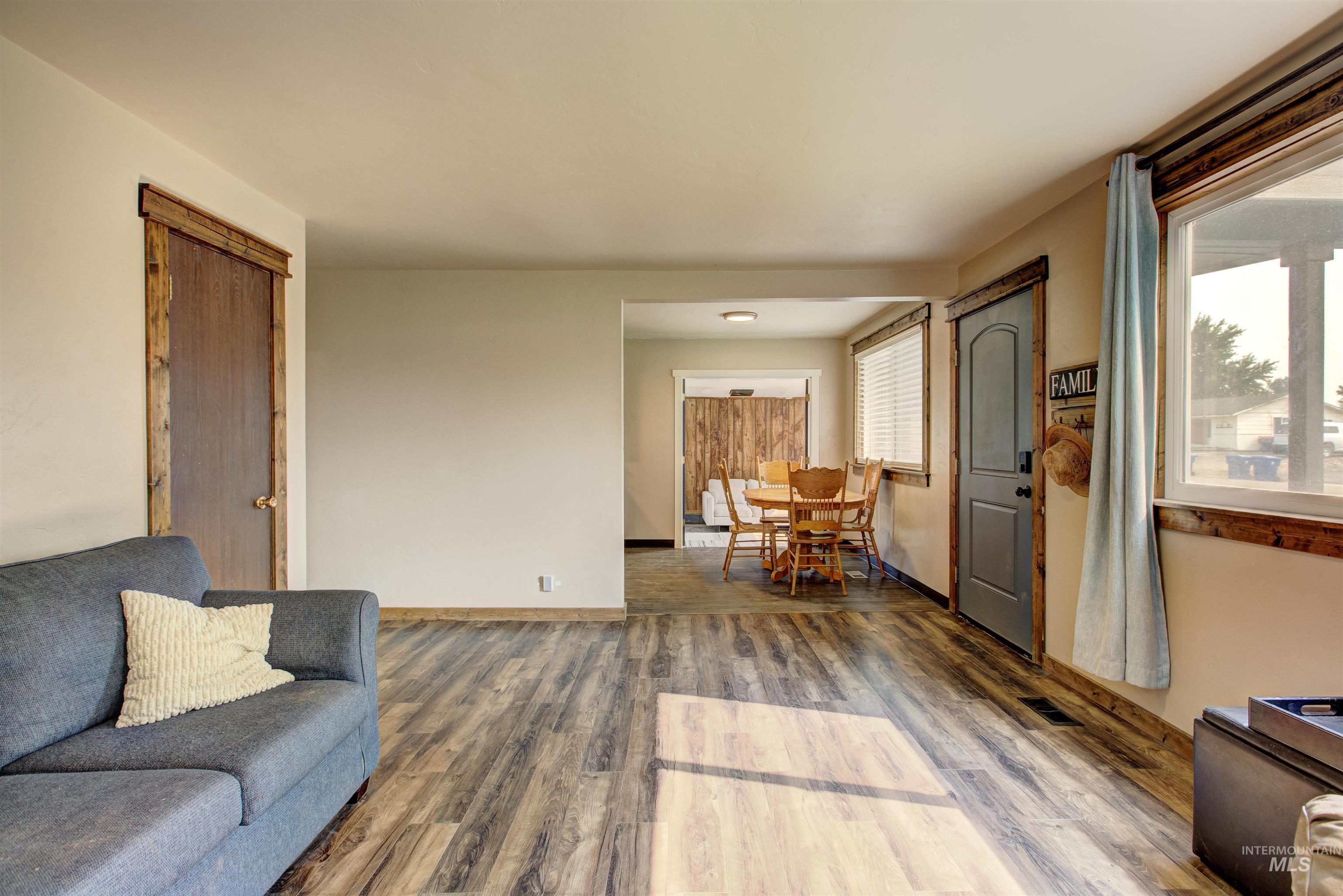 Living area with wood finished floors and baseboards