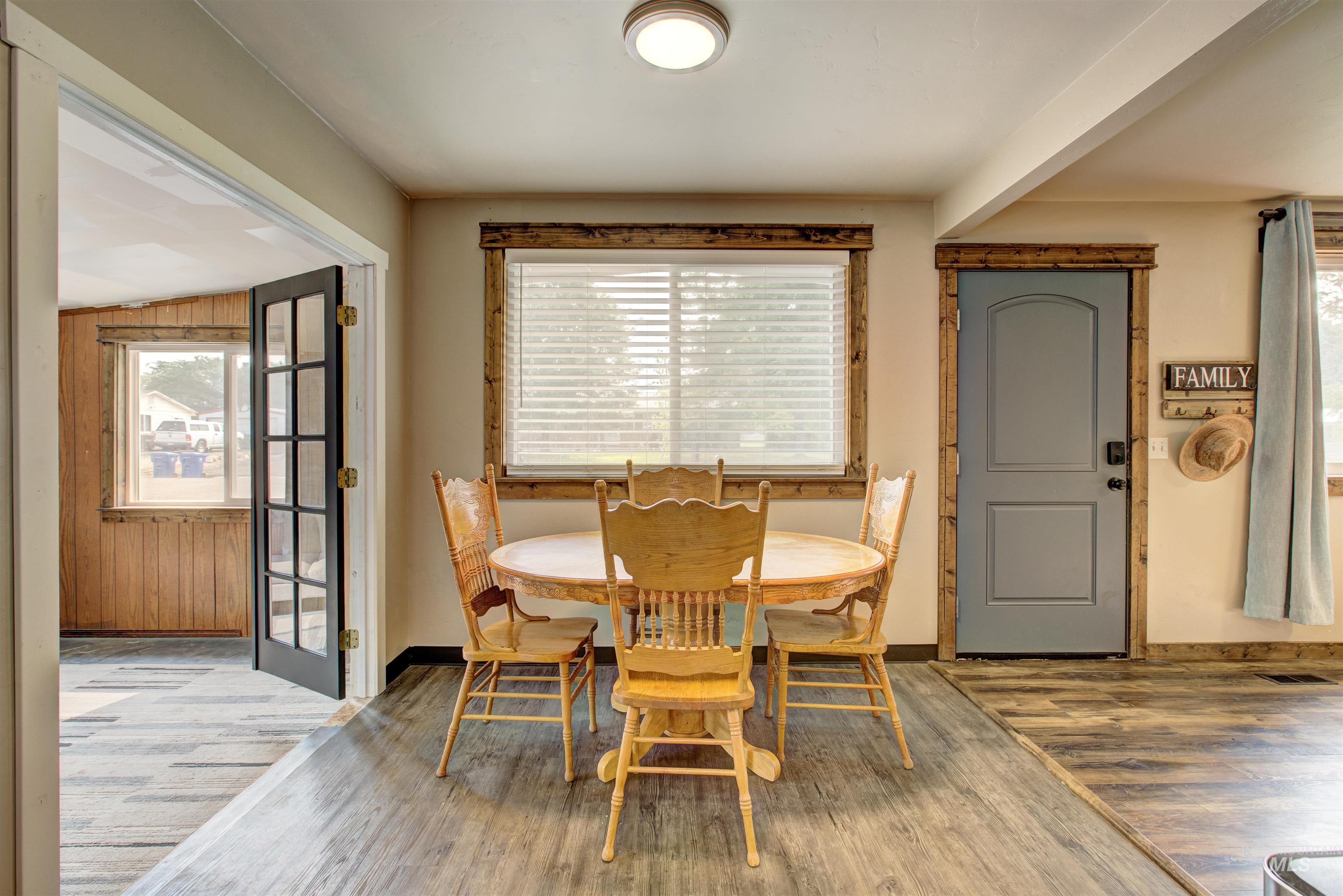 Dining area featuring healthy amount of natural light, wood finished floors, and wooden walls