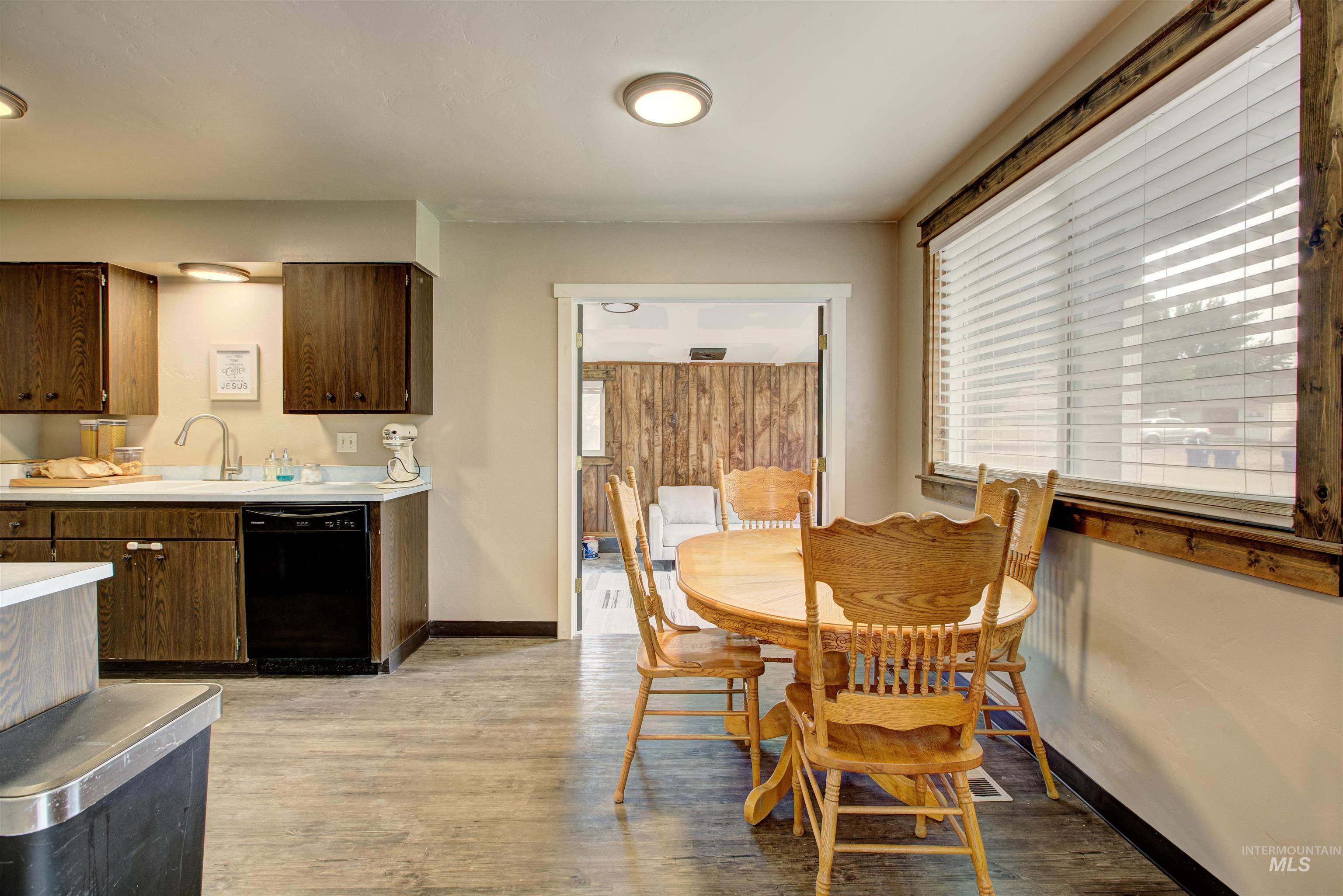 Dining space featuring light wood-type flooring and baseboards