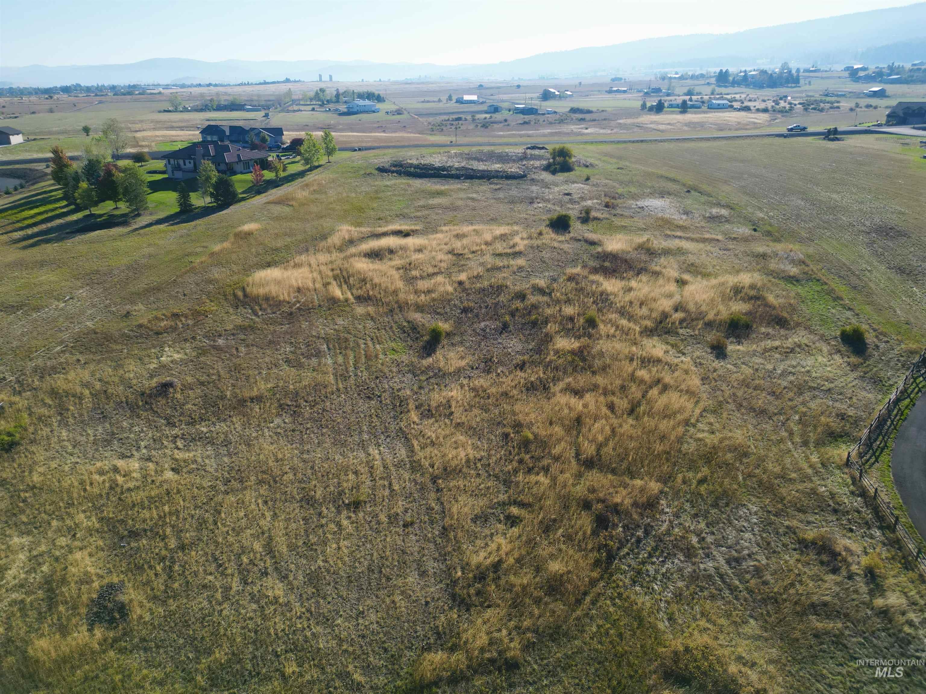 Aerial overview of property's location with a mountainous background and rural landscape