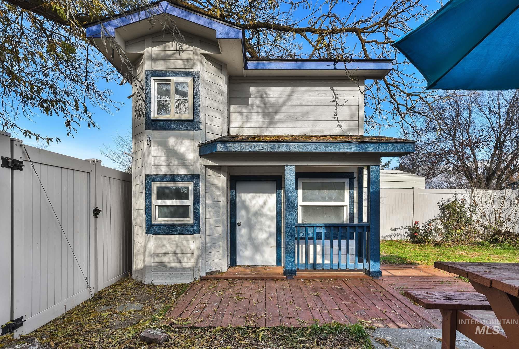 View of exterior entry with a deck and a gate