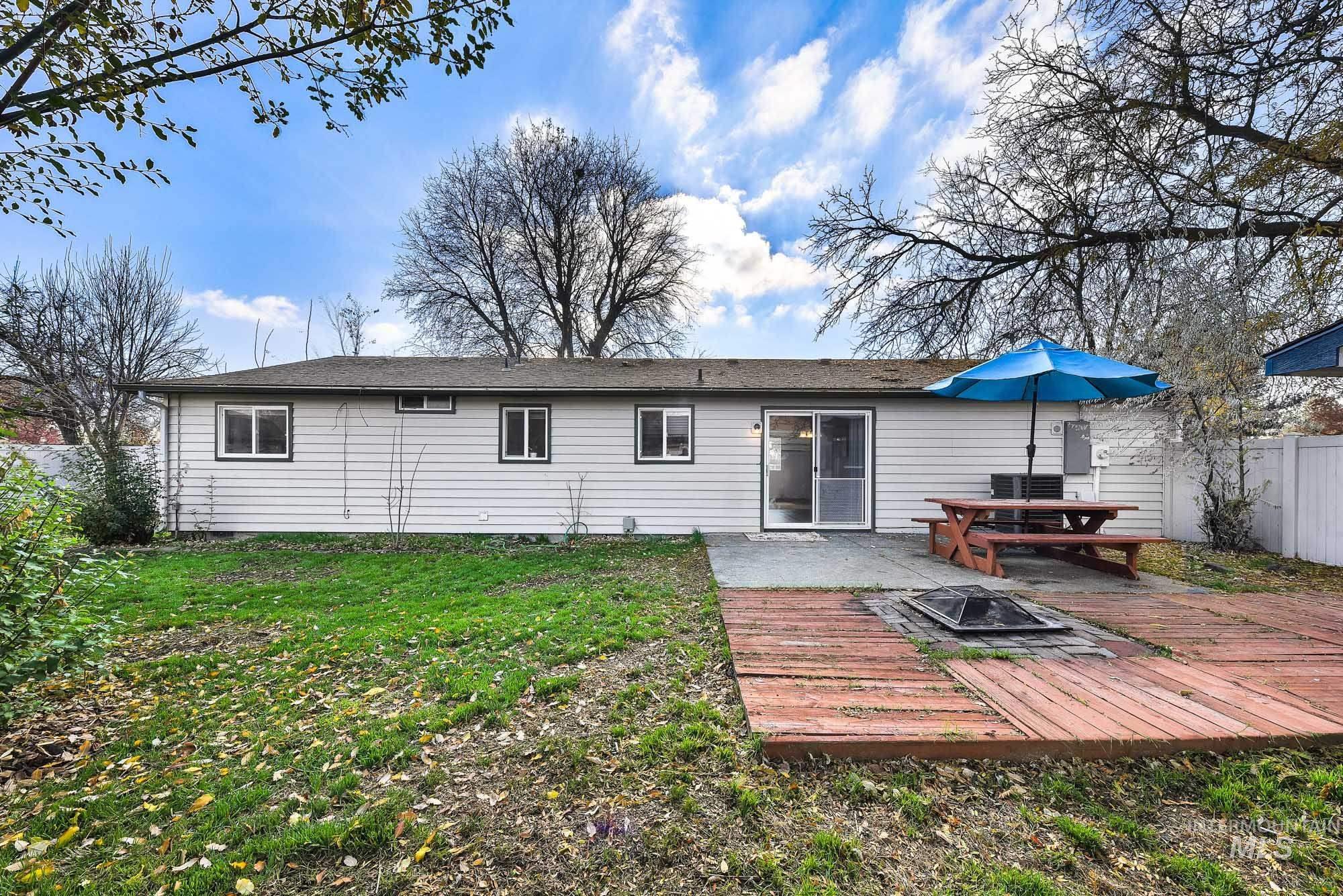 Back of house with an outdoor fire pit and a patio area