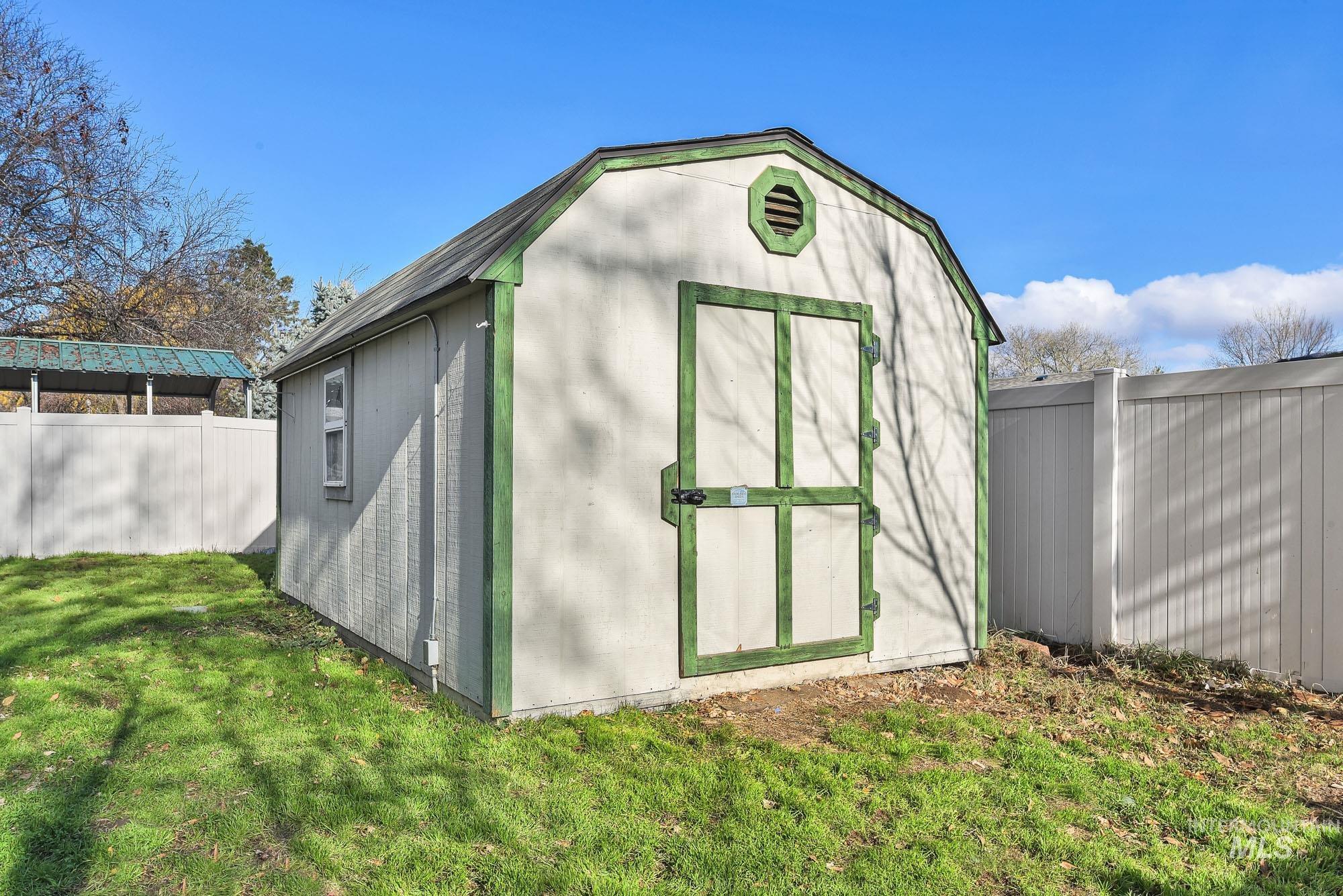 View of shed that is insulated and includes power with a fenced backyard