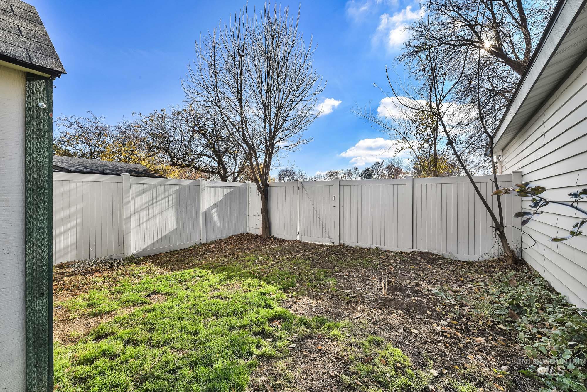 Fenced backyard with a gate