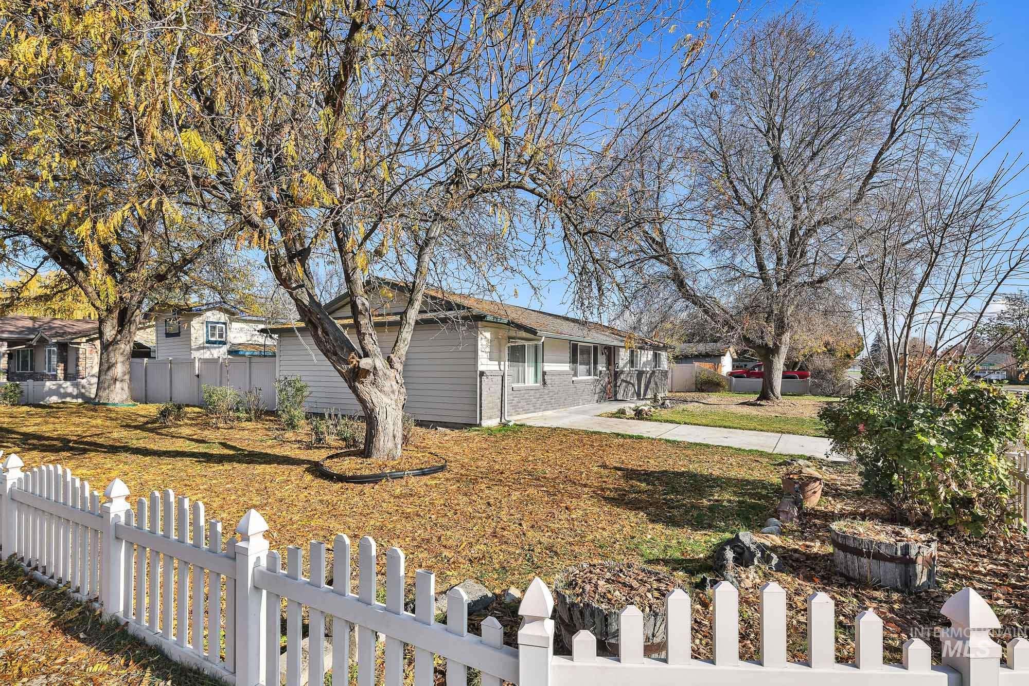 View of front and side of house featuring a fenced front yard and brick siding