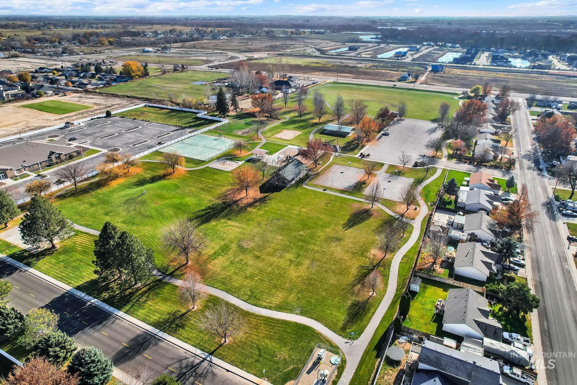 Aerial overview of property's location featuring nearby expansive park and suburban area
