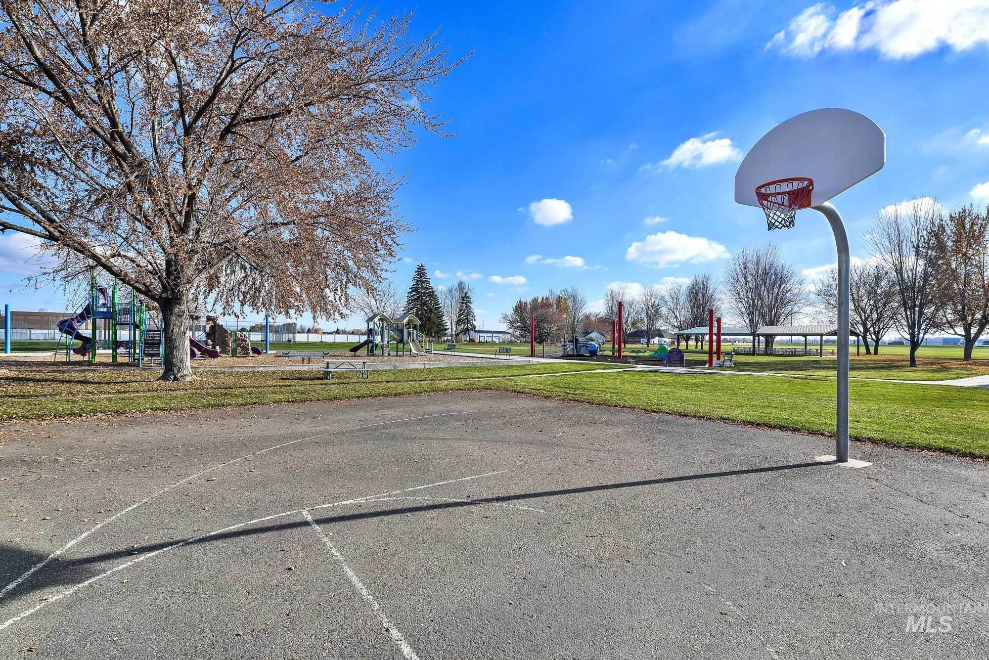 View of sport court with community basketball court and a yard