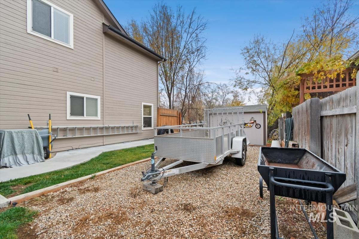 Fenced backyard with an outbuilding and a patio