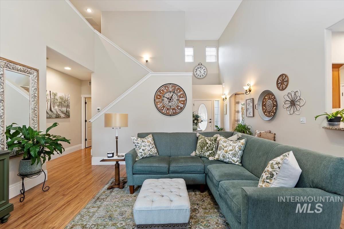 Living room with a towering ceiling and wood finished floors