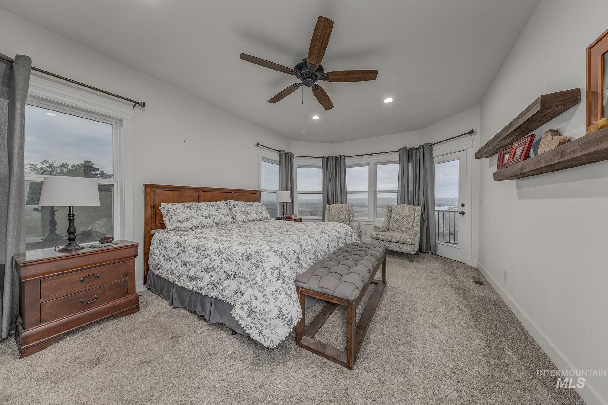 Bedroom featuring multiple windows, light carpet, a ceiling fan, access to outside, and recessed lighting