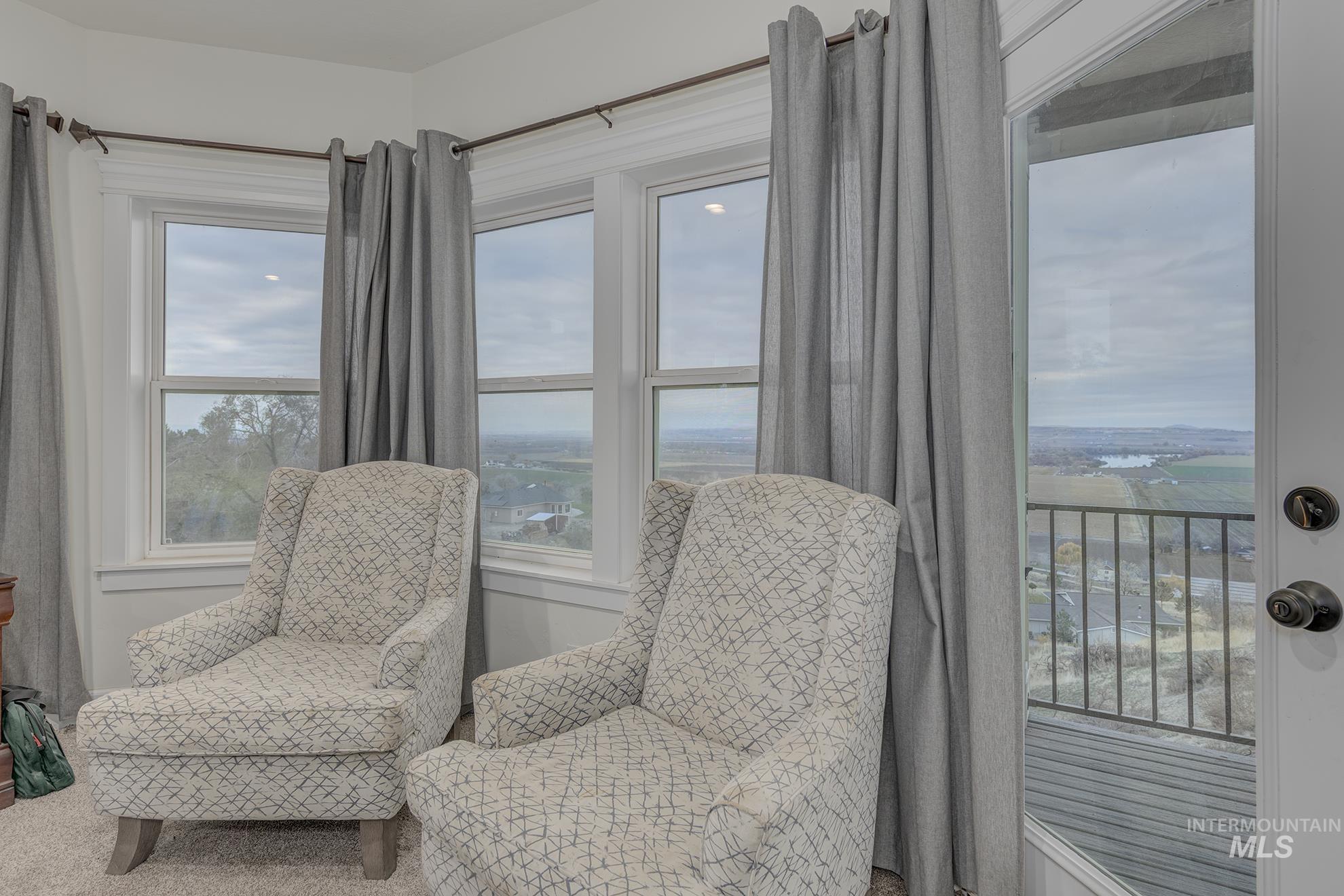 Living area featuring healthy amount of natural light and carpet floors
