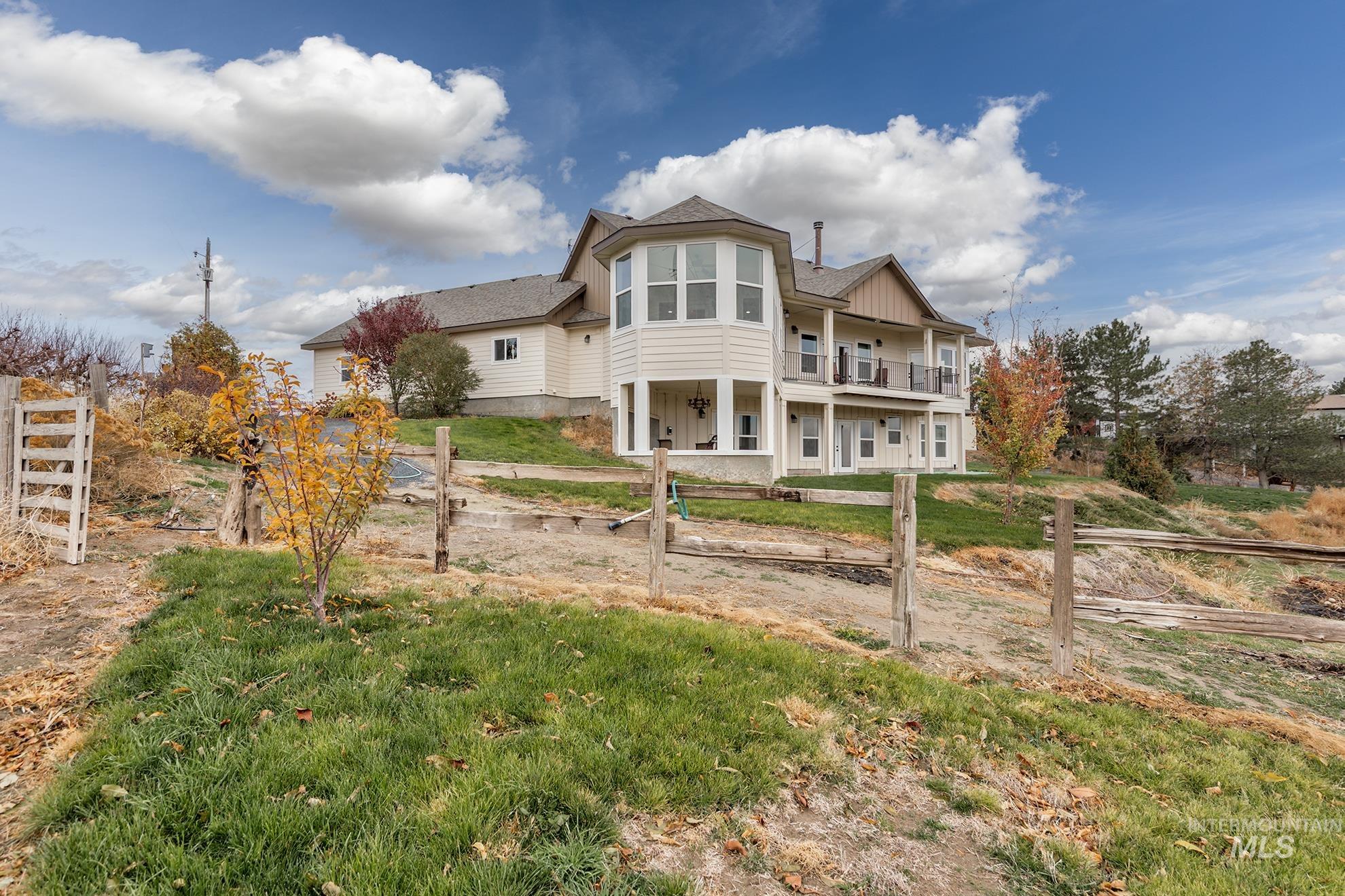 Back of property featuring a lawn, a shingled roof, and board and batten siding