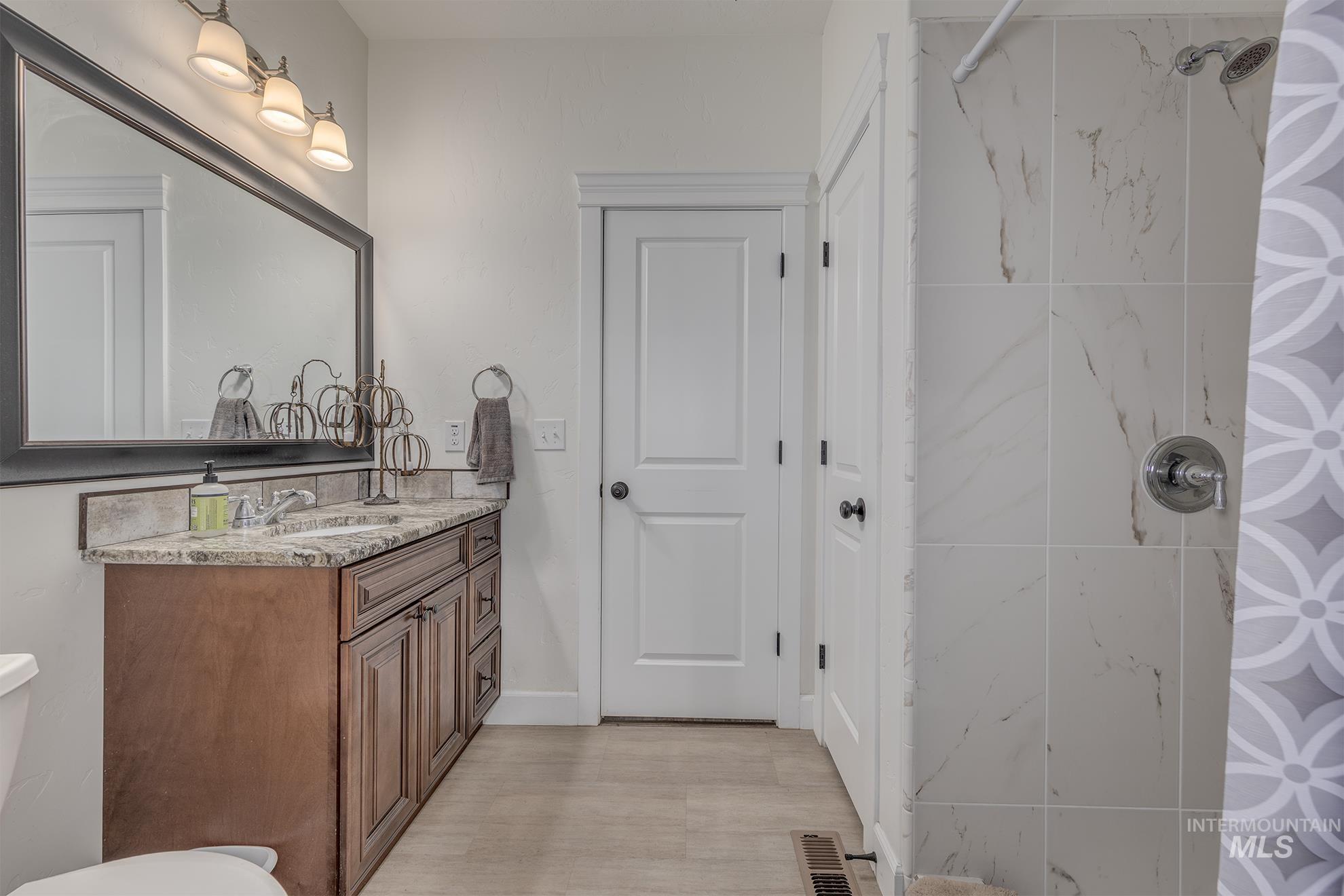 Full bathroom with vanity and a tile shower