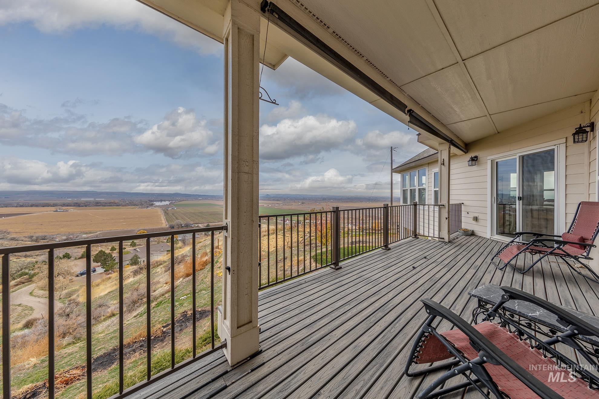 Wooden terrace featuring a view of countryside