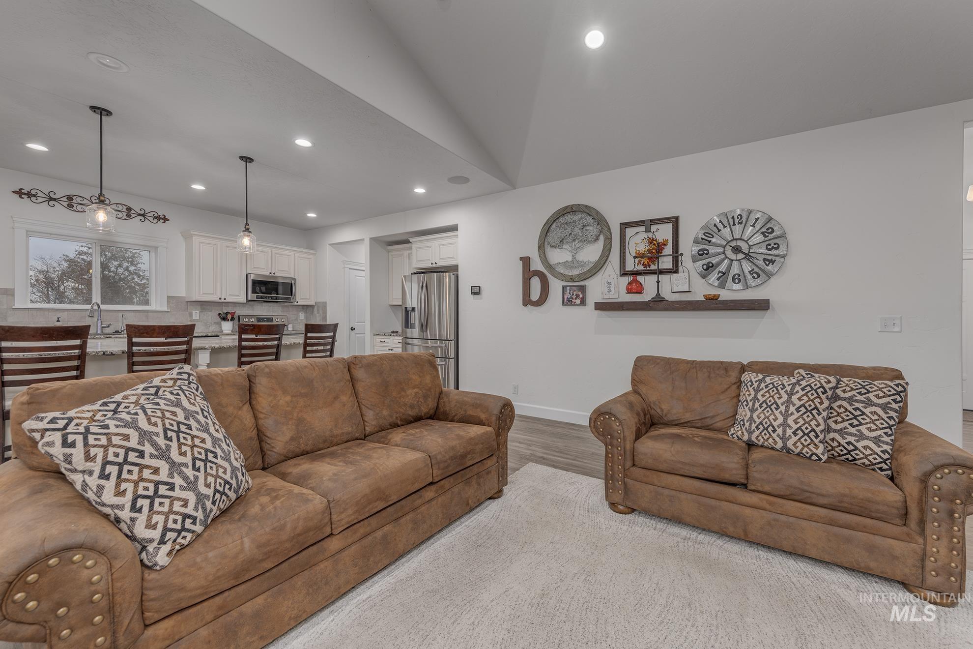 Living area with recessed lighting and wood finished floors