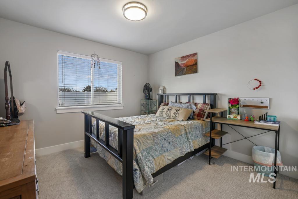Bedroom with light colored carpet