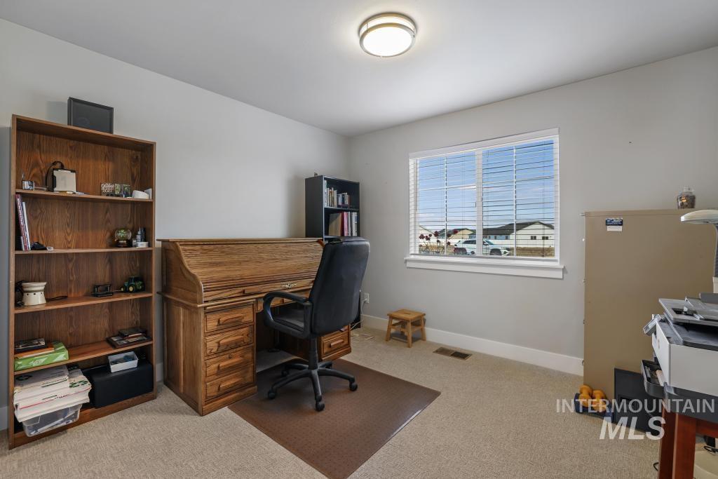 Office area featuring light carpet