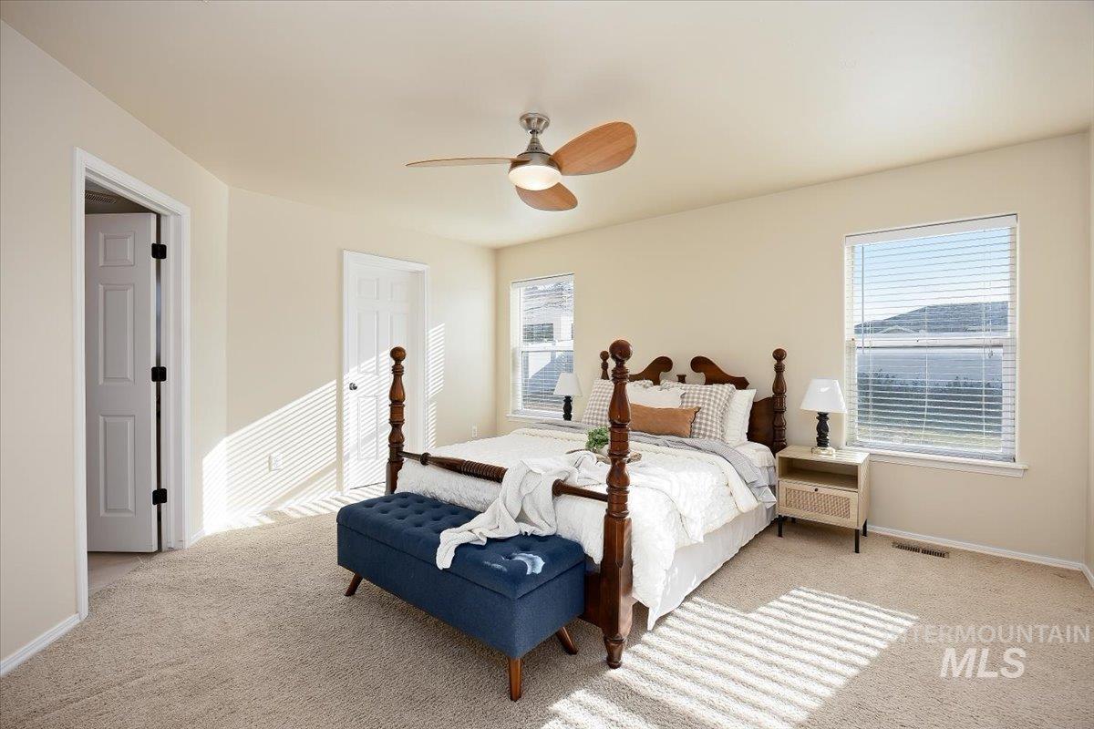 Bedroom featuring carpet floors, ceiling fan, and a closet