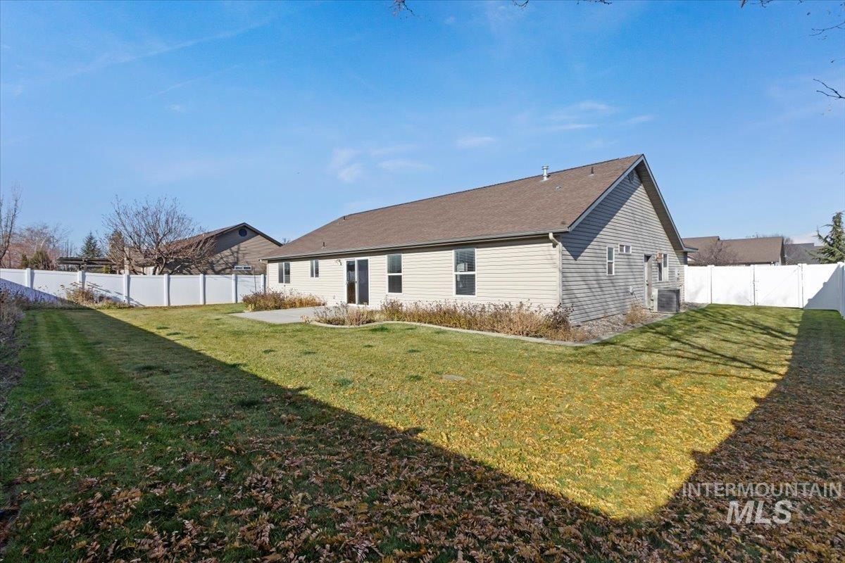 Rear view of property featuring a fenced backyard
