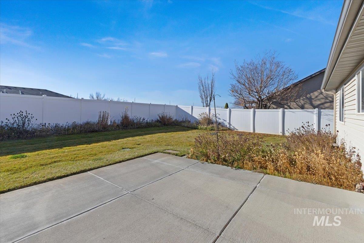 Fenced backyard with a patio