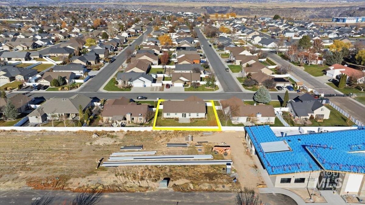 Aerial view of residential area featuring property boundaries highlighted