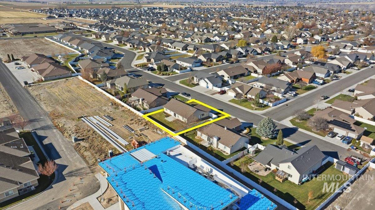 Aerial view of residential area with property boundaries highlighted