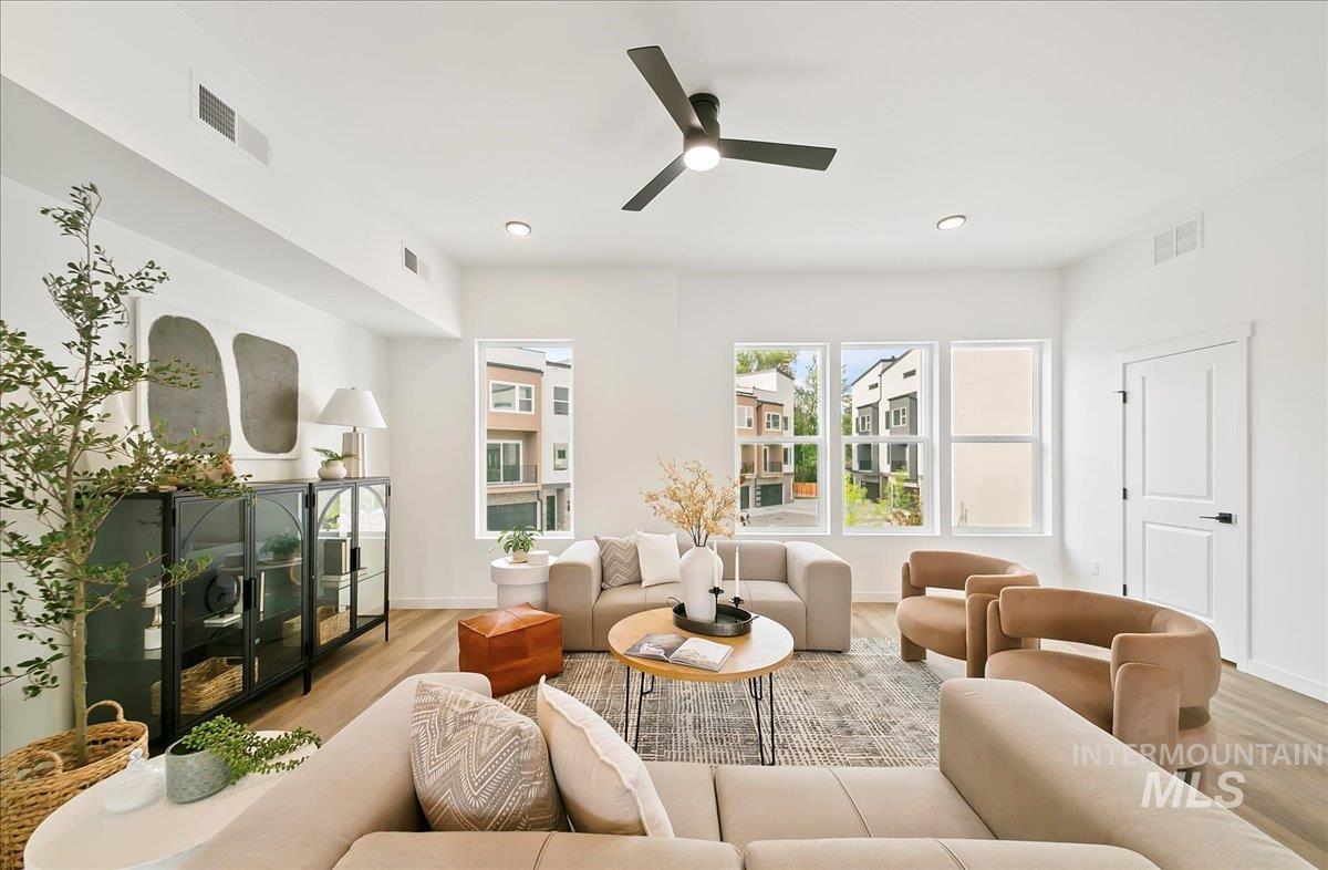 Living area featuring a ceiling fan, light wood finished floors, and recessed lighting