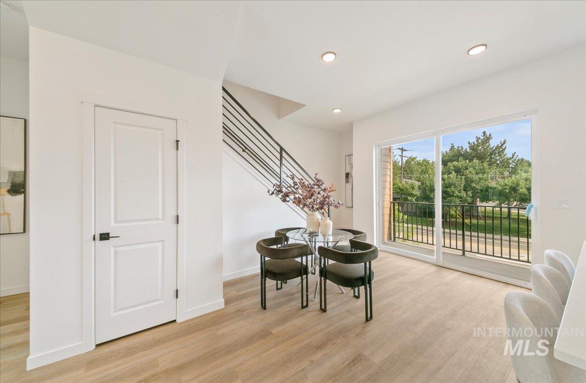 Dining room featuring light wood-style floors, stairs, and recessed lighting