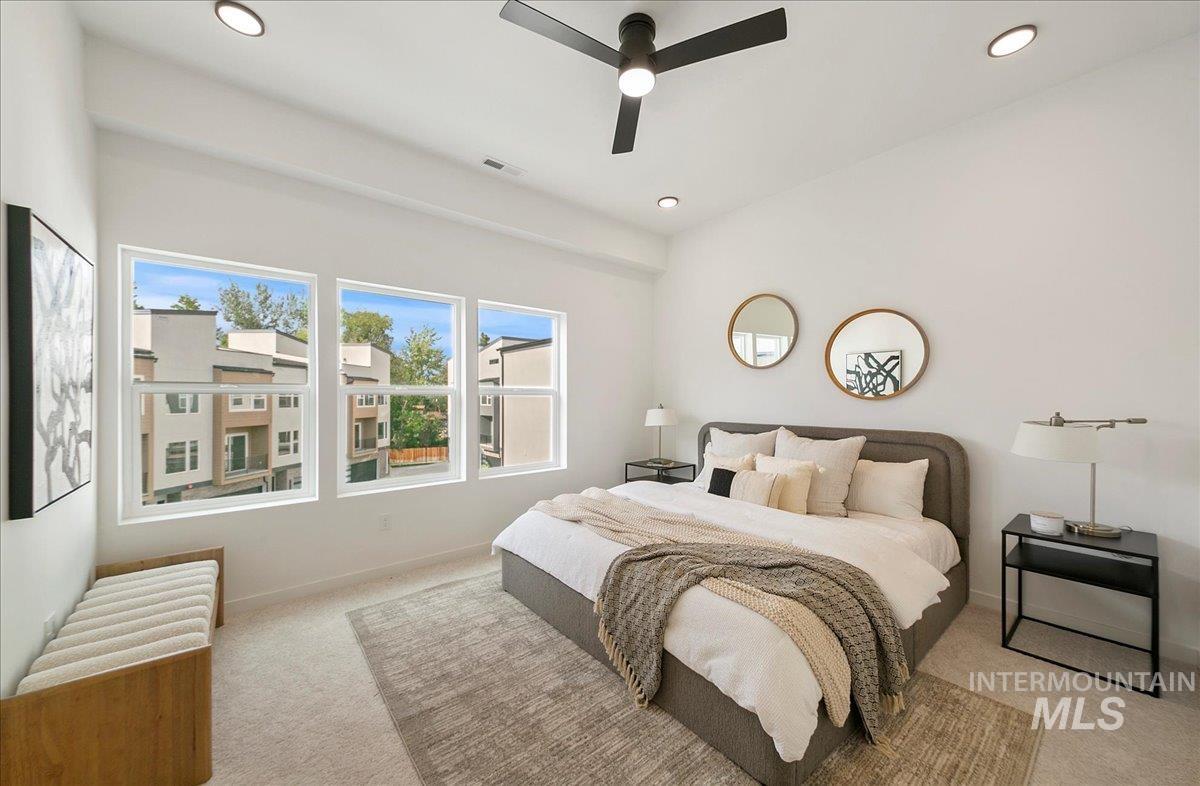 Bedroom with light carpet, recessed lighting, and a ceiling fan