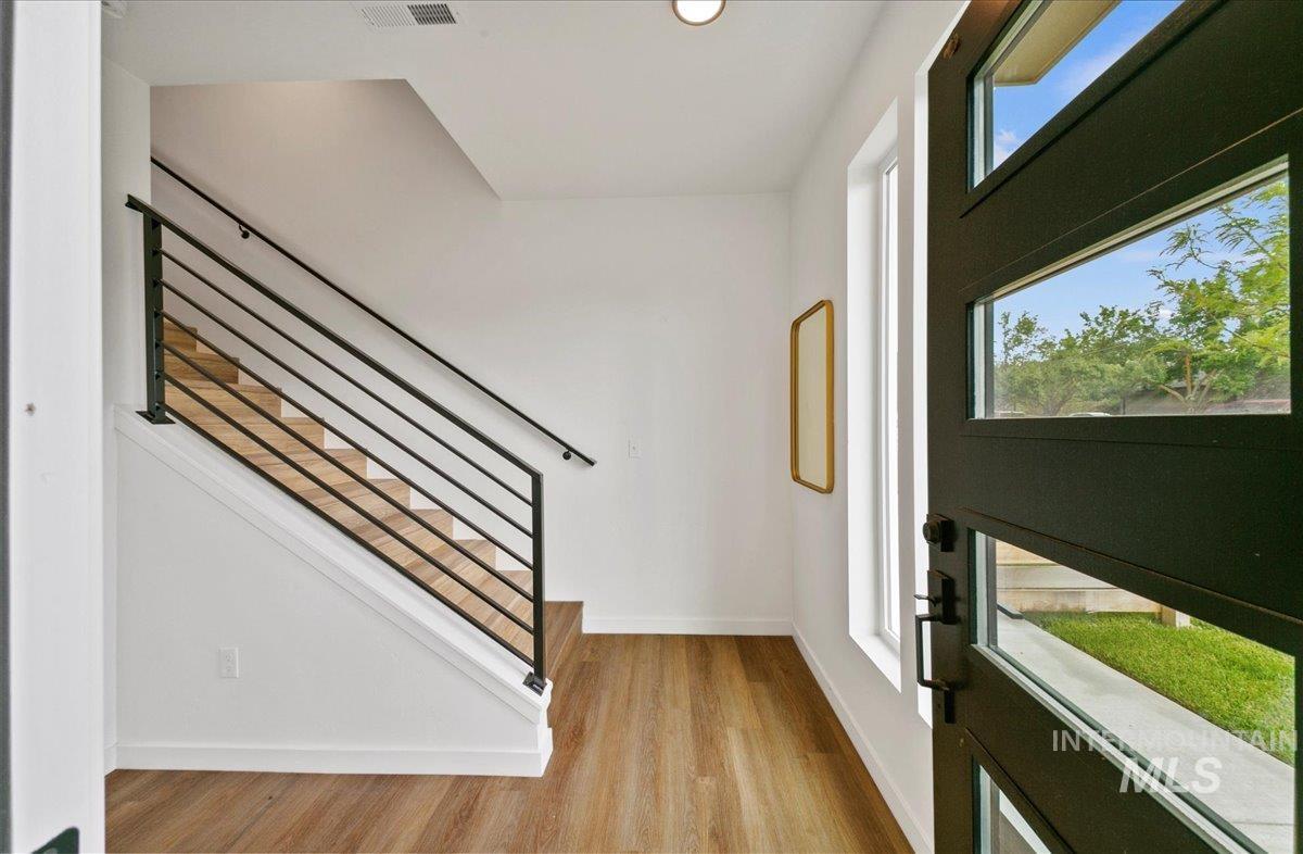 Foyer entrance featuring plenty of natural light and wood finished floors