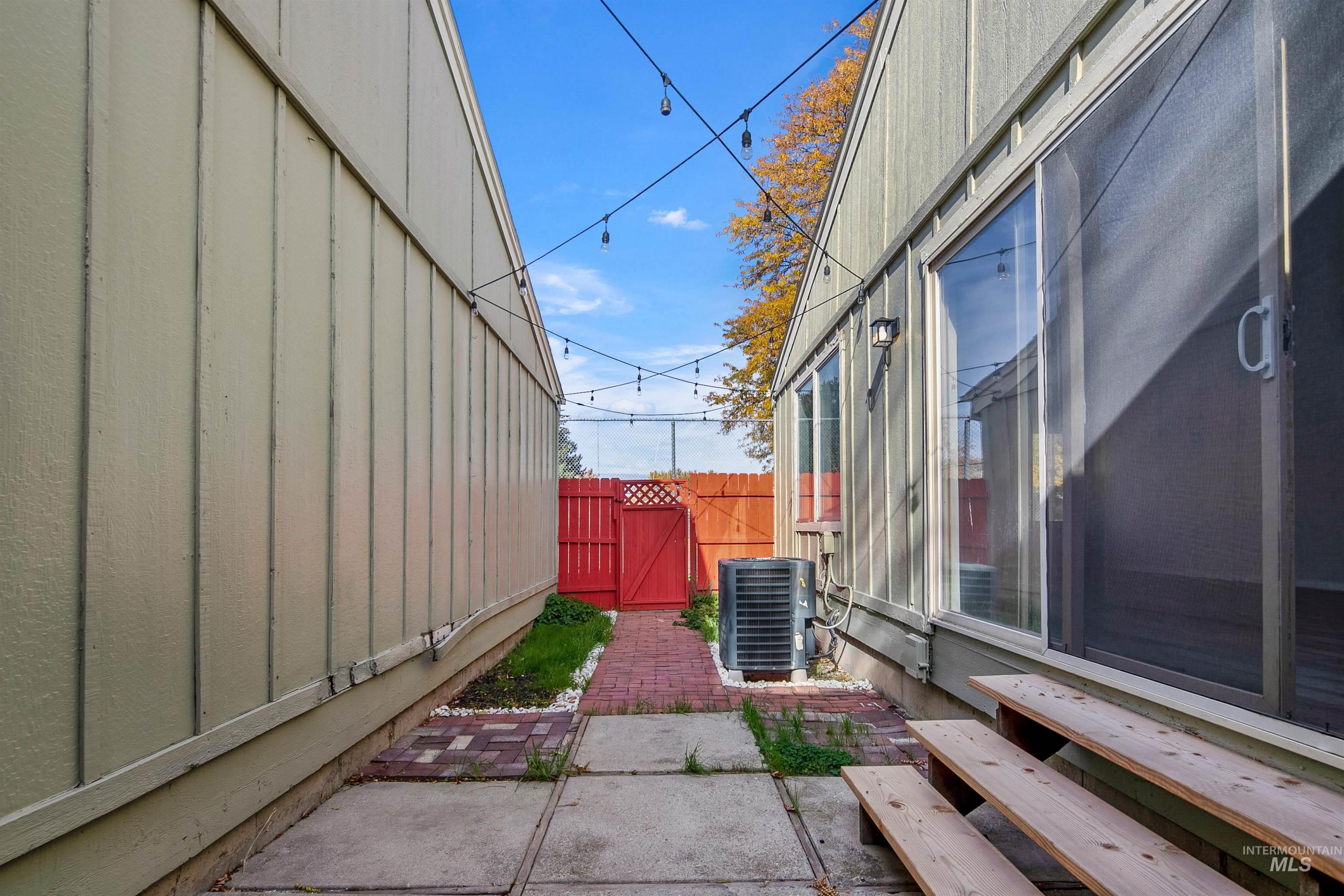 View of patio with a gate and entry steps