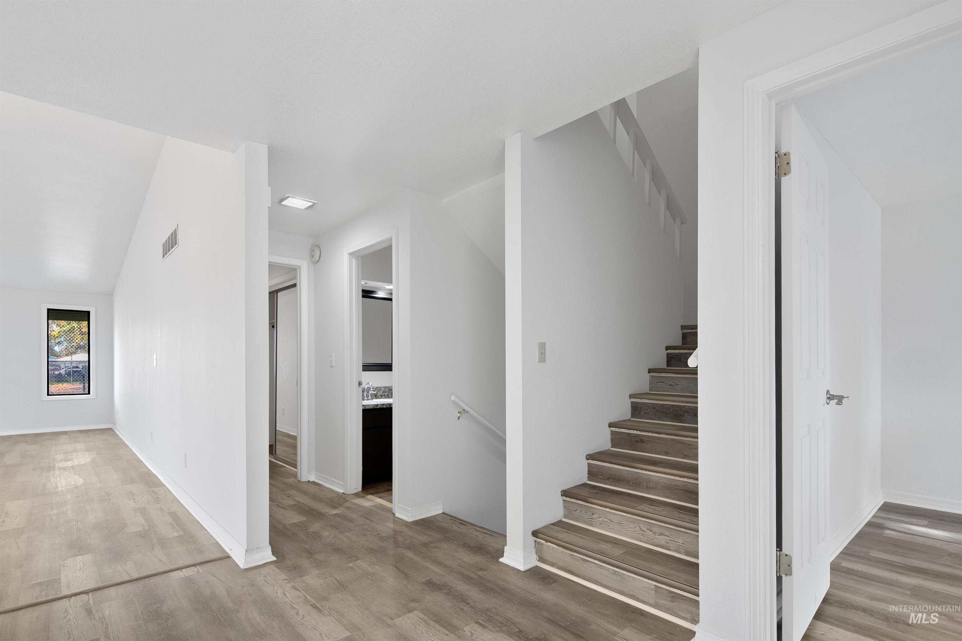 Stairway featuring wood finished floors and baseboards