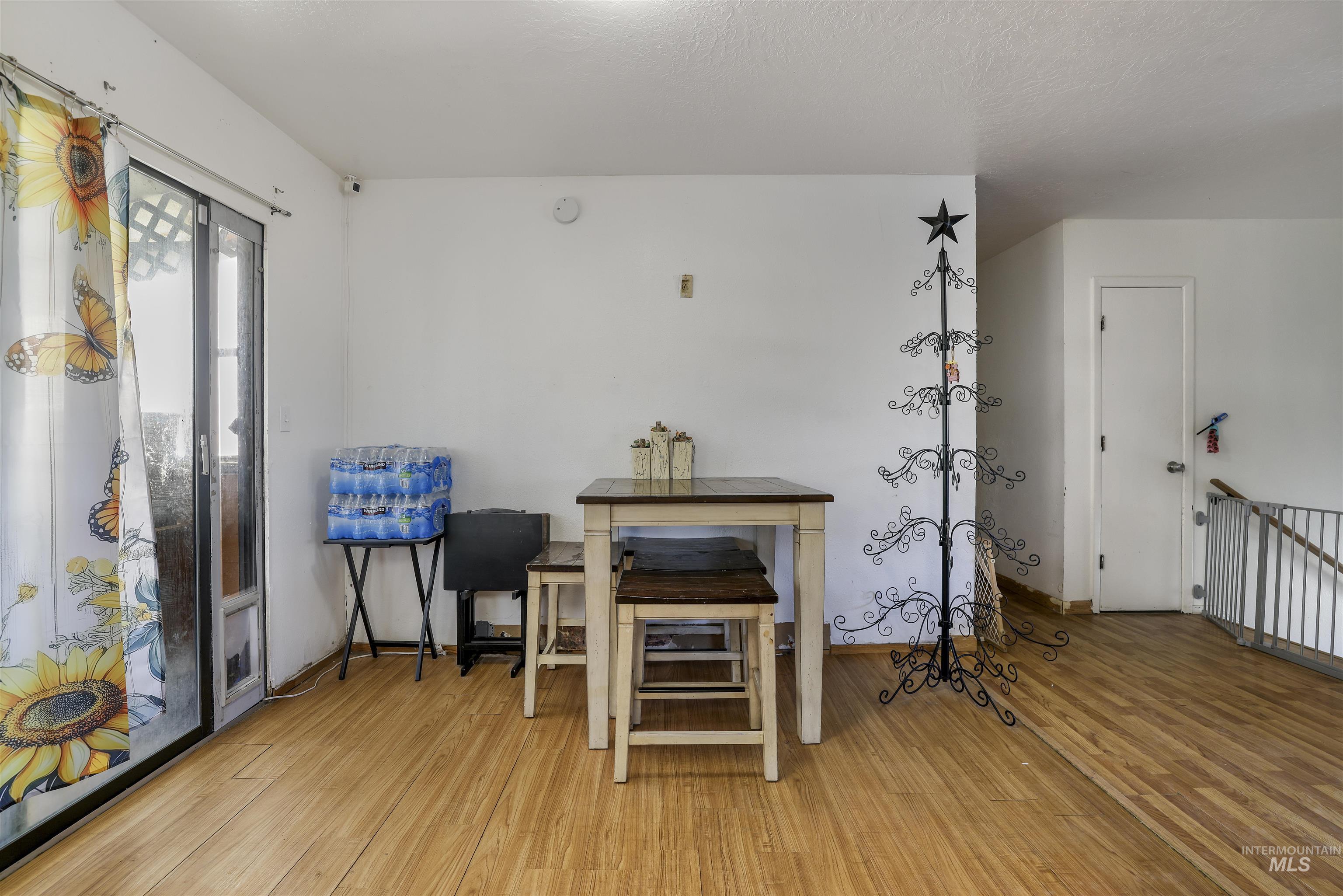 Living area with light wood-type flooring and baseboards