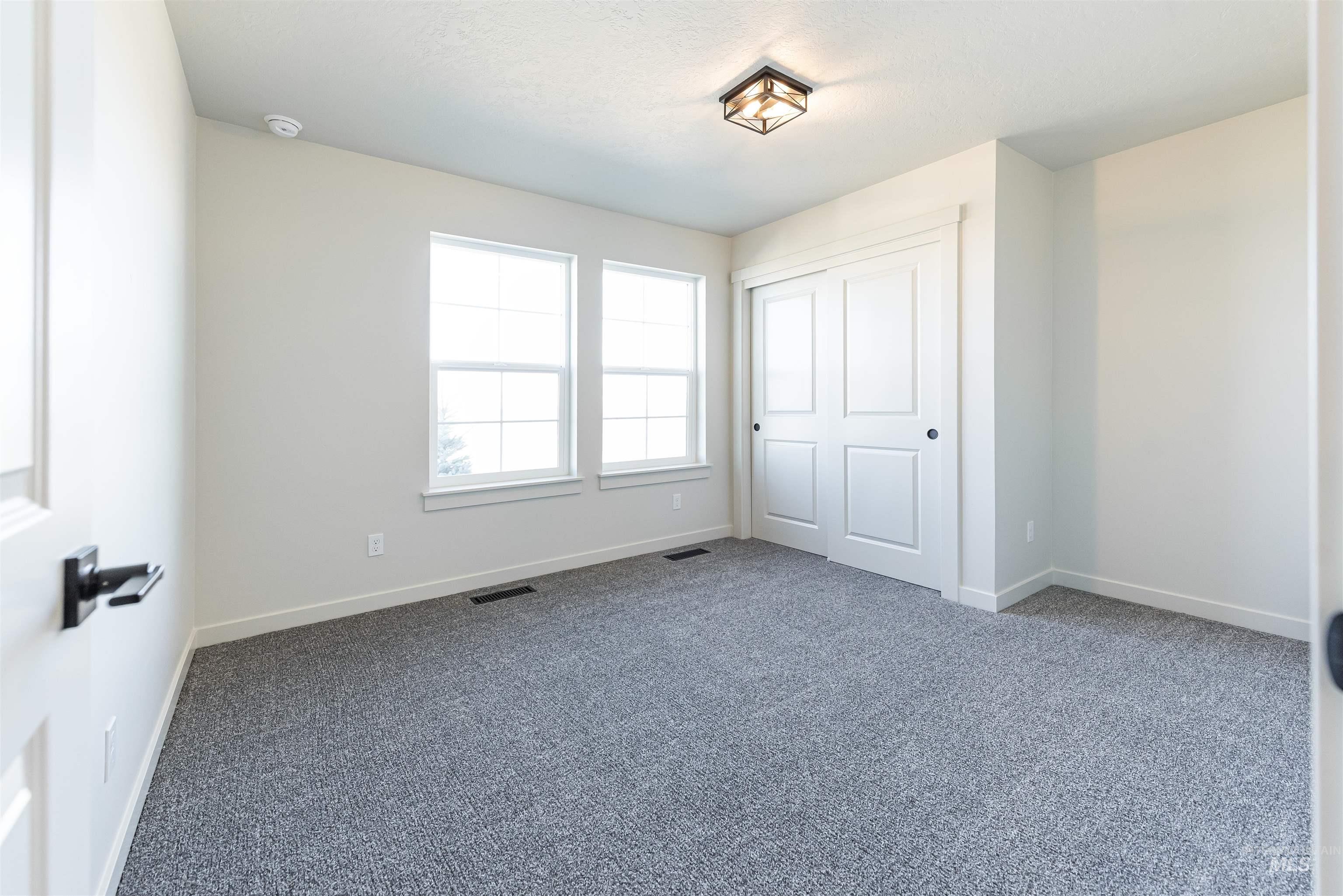 Unfurnished bedroom featuring carpet and a closet