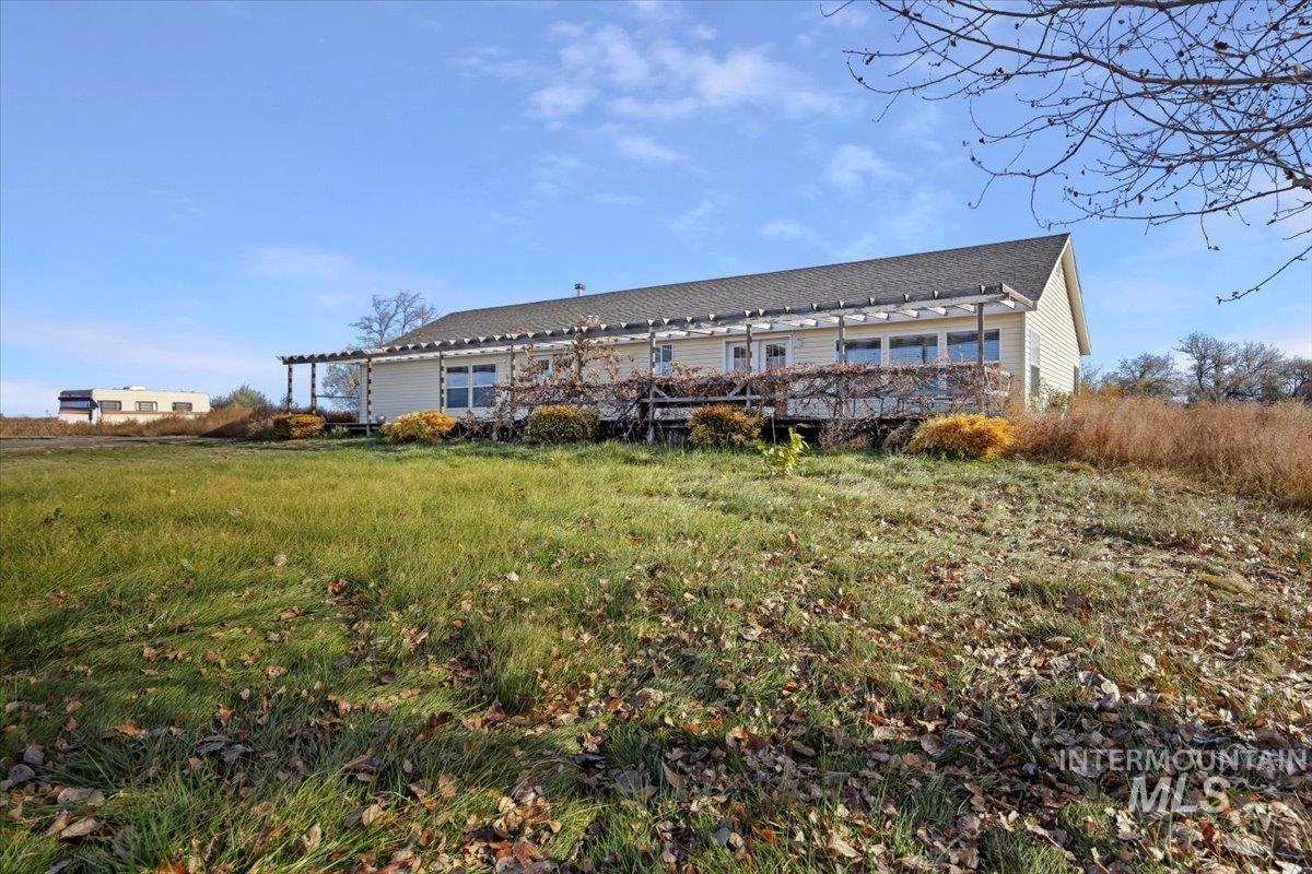 Rear view of house with a pergola