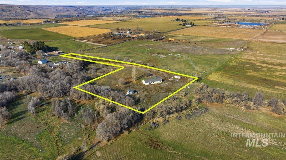 Aerial view of sparsely populated area with property parcel outlined