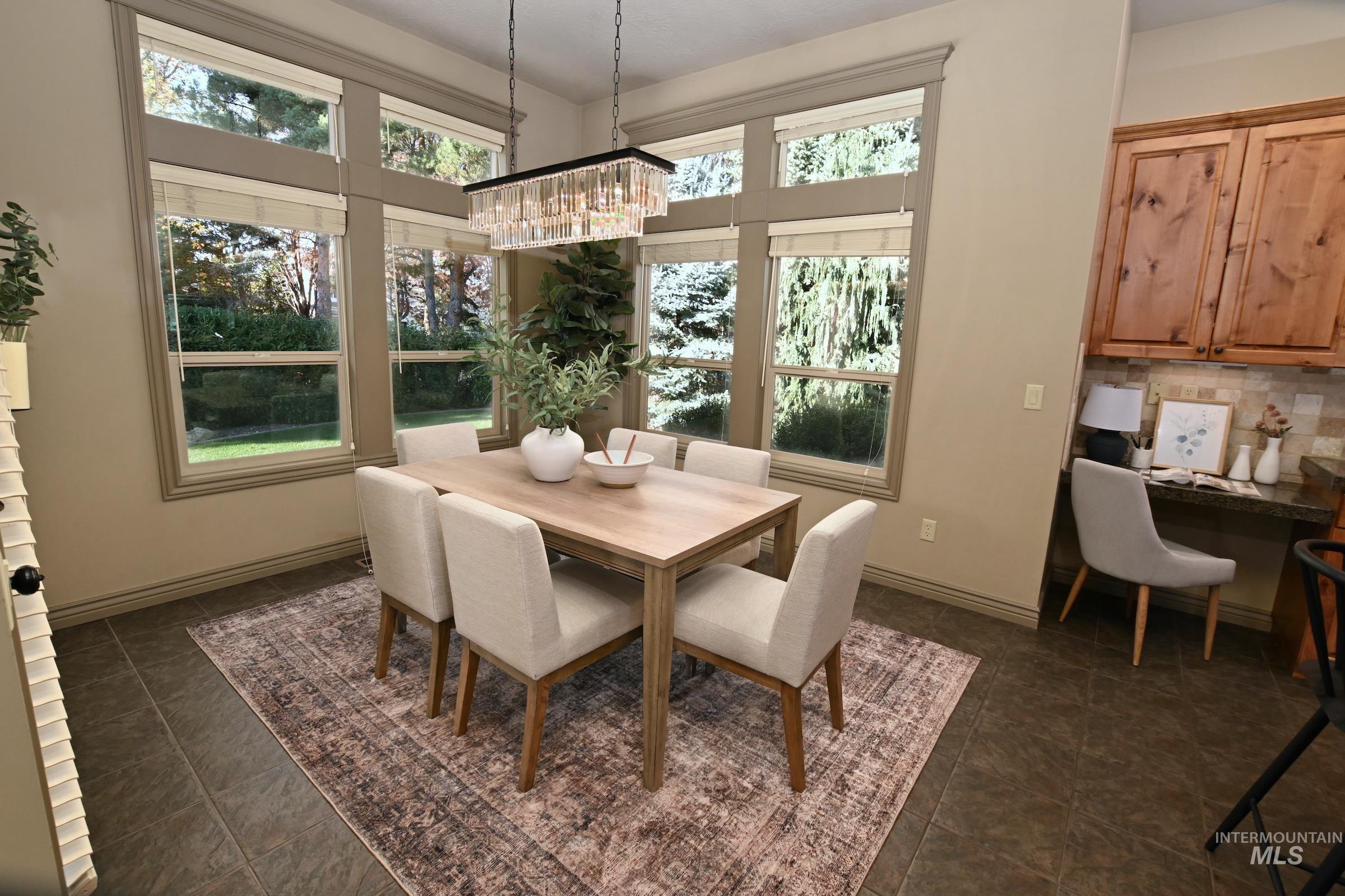 Dining space featuring a chandelier and a desk