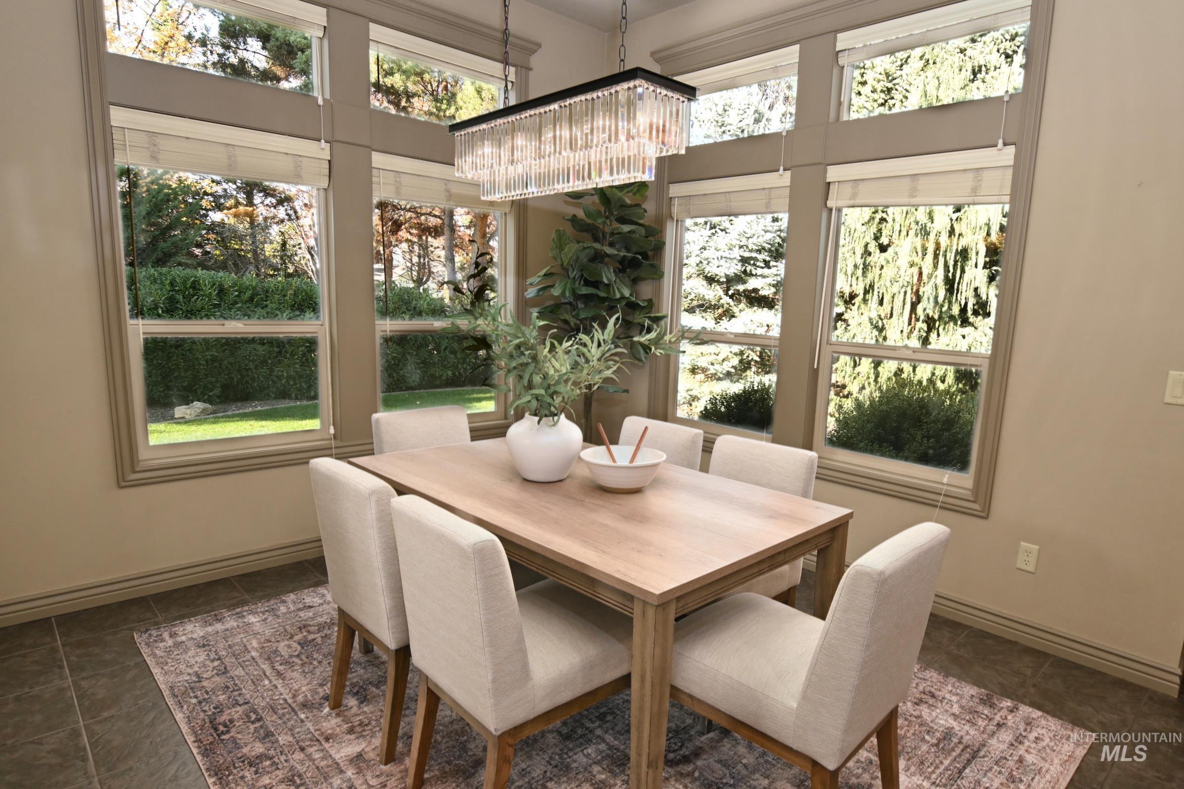 Dining area featuring a chandelier and baseboards