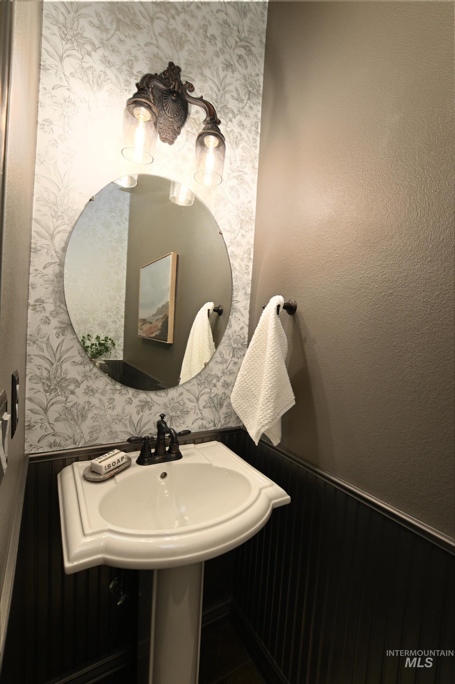 Bathroom featuring wainscoting and wood walls