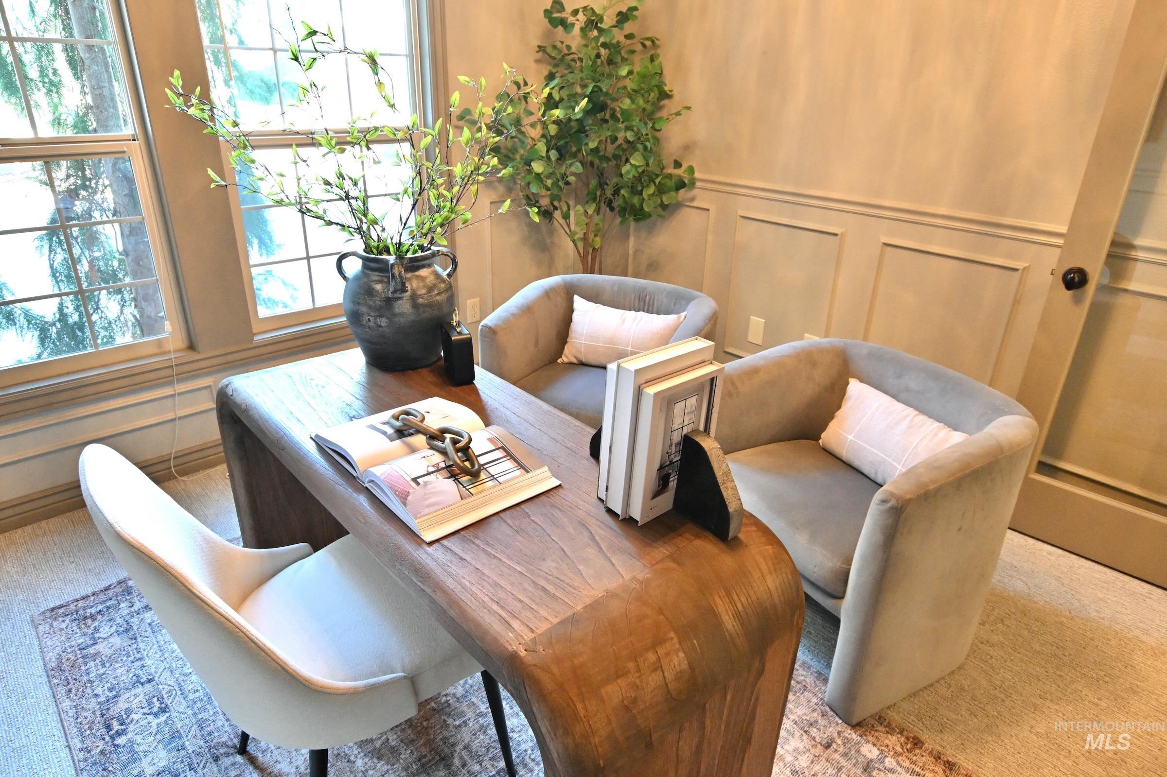Sitting room with a decorative wall and carpet flooring
