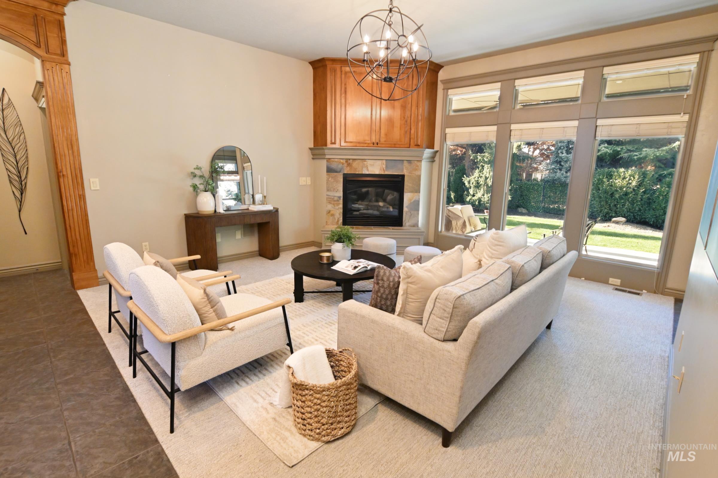 Tiled living area with a chandelier and a tiled fireplace