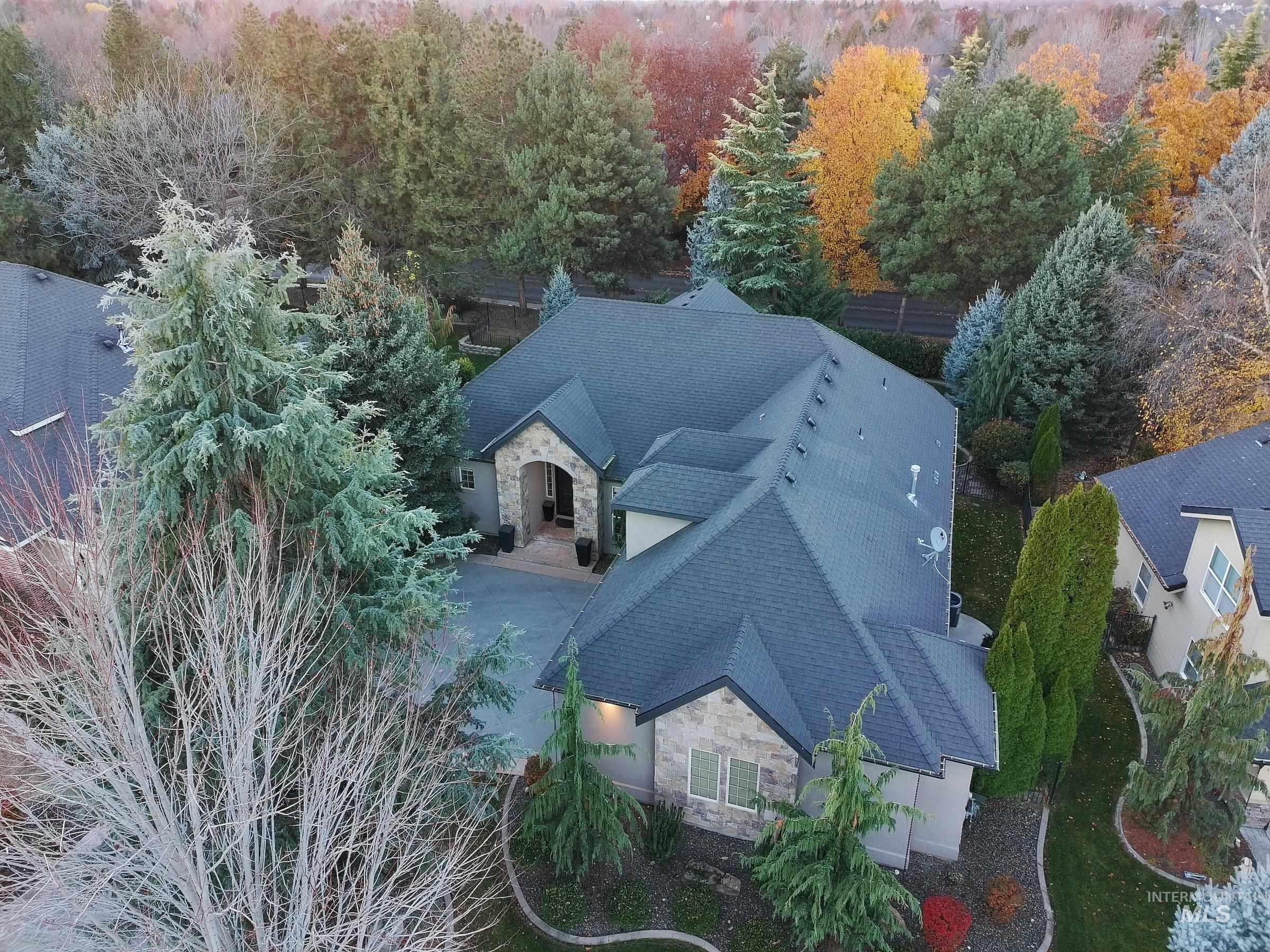 Aerial view of property and surrounding area featuring a forest